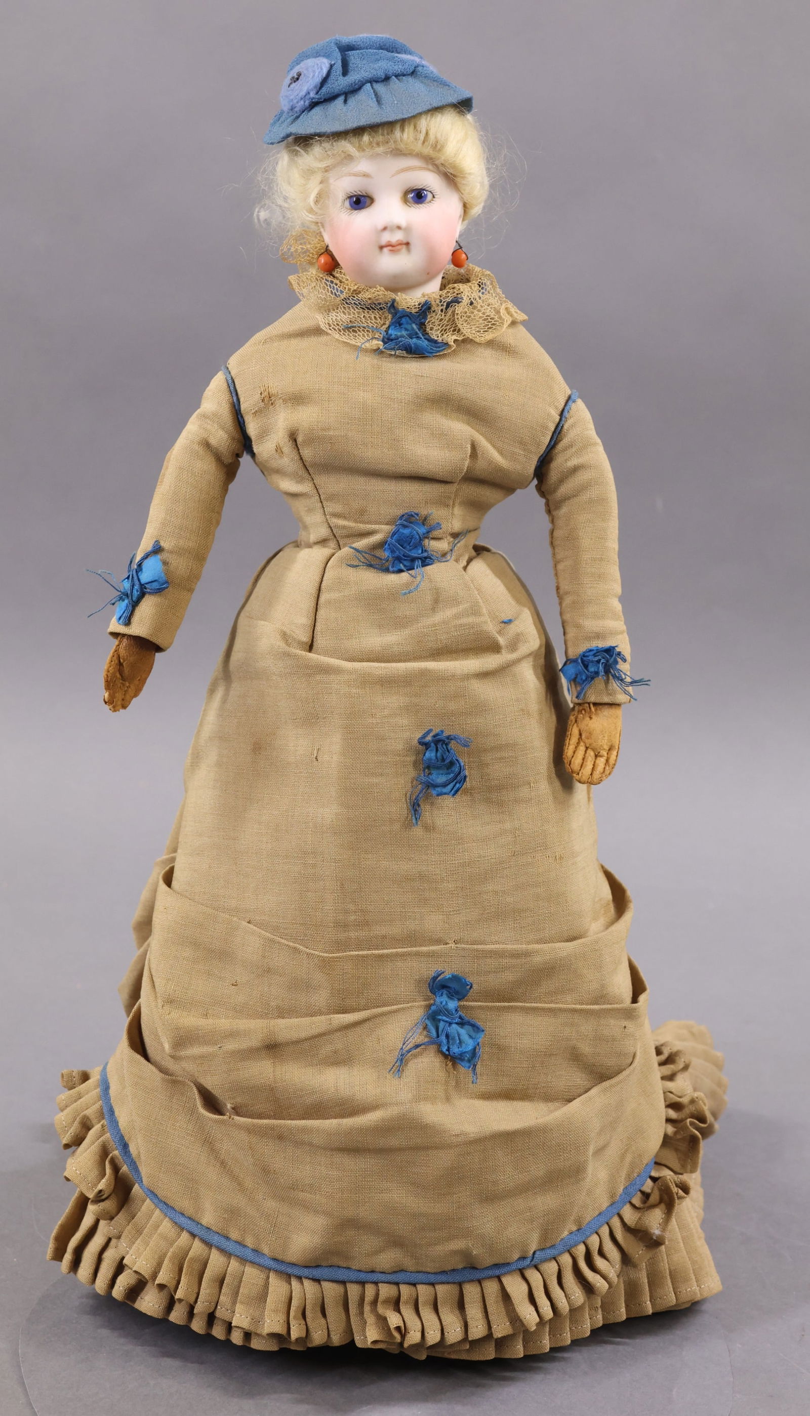 ANTIQUE FRENCH BISQUE HEAD DOLL.: 14 1/2" Unmarked French Fashion Doll. Blue paperweight eyes, closed mouth, pierced ears, newer pale blonde curly mohair wig, cork pate. Socket head on a bisque shoulder plate. Cloth body hinged at hip