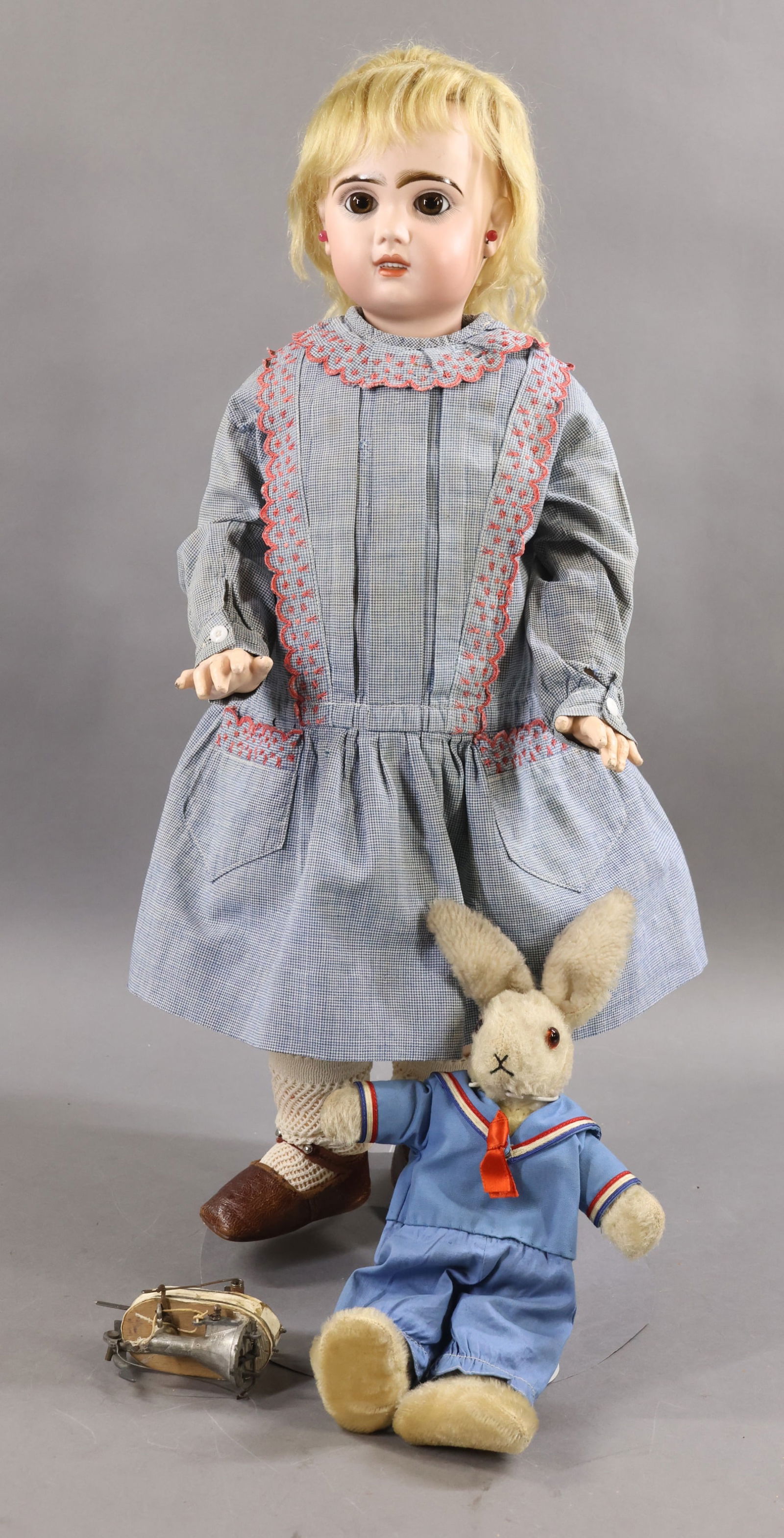 ANTIQUE FRENCH BISQUE HEAD DOLL.: LOT. 24" (Incised) "10" (Red stamp) JUMEAU Doll. Brown paper weight eyes, open mouth, pierced ears, blonde mohair wig, cork pate. Papier mache jointed body is marked with the paper label BEBE JUMEAU.
