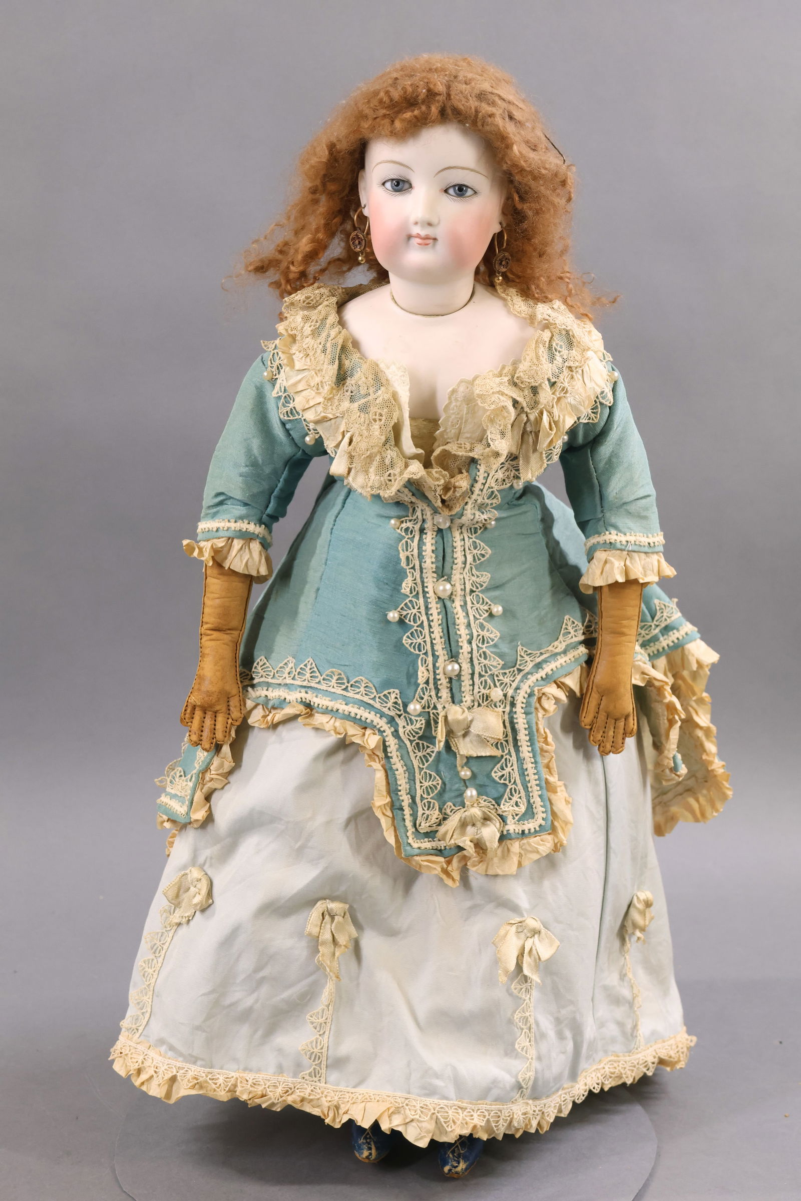 ANTIQUE FRENCH BISQUE HEAD DOLL.: 19" "5" French Fashion Doll. Blue paperweight eyes, closed mouth, pierced ears, very curly brown mohair wig, cork pate. Socket head on a bisque shoulder plate marked "5" on shoulder. Antique body with
