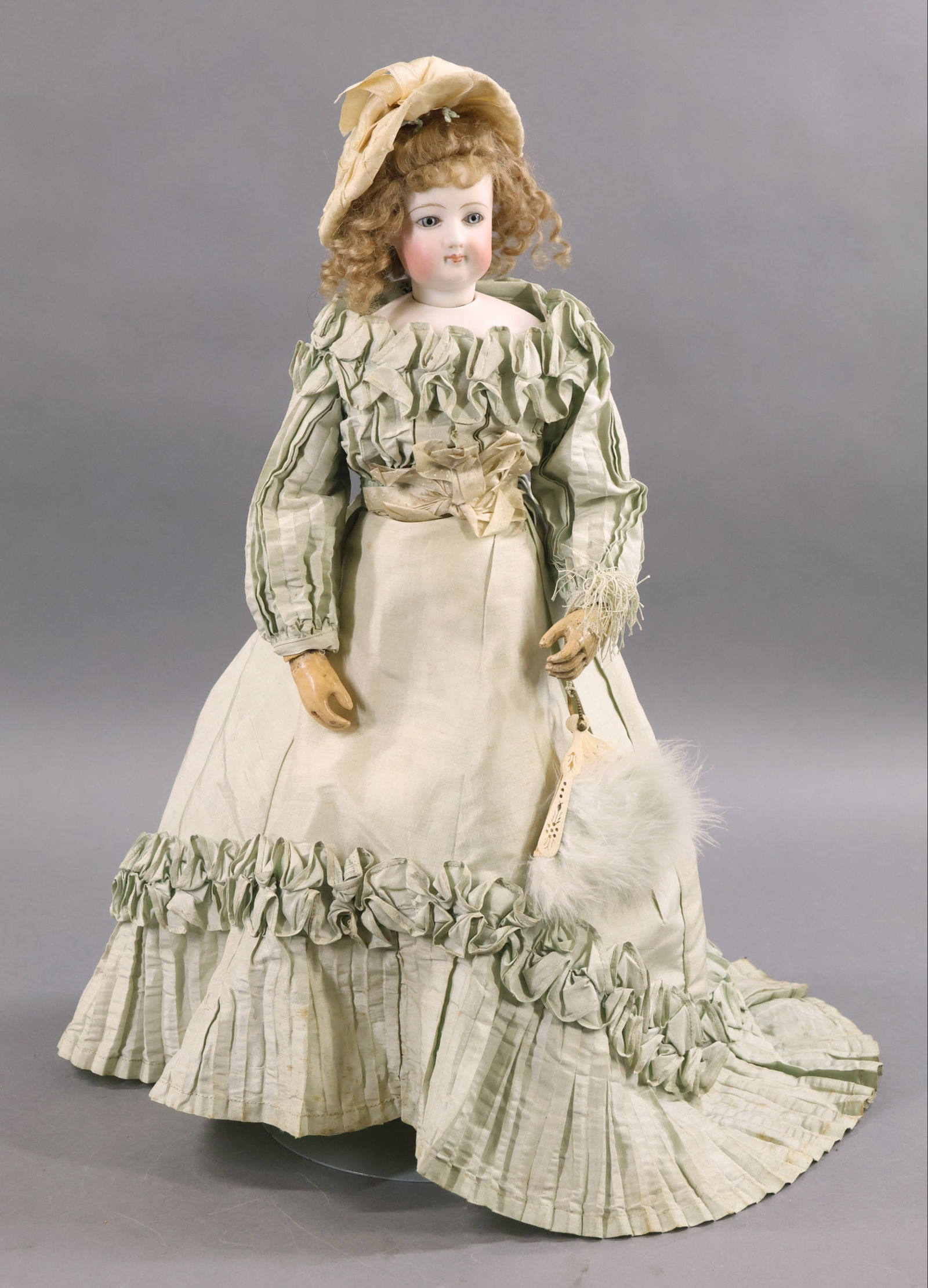 ANTIQUE FRENCH BISQUE HEAD DOLL.: 19" "4." French Fashion Doll. Pale blue paper weight eyes, closed mouth, pierced ears, curly honey blonde mohair wig, cork pate. Bisque socket head on a bisque shoulder plate marked "4" on shoulder.