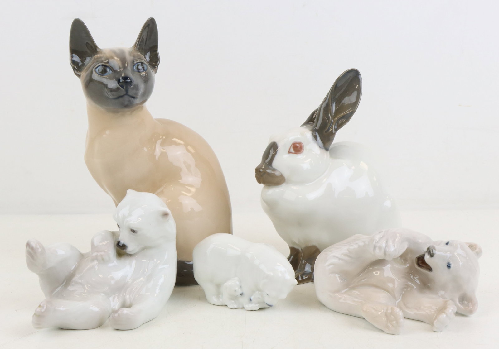 Royal Copenhagen Porcelain Figures: Royal Copenhagen porcelain animal figures, includes polar bears (3), Siamese cat and rabbit, marked. Cat 7.5”h x 4.25”w x 3”d