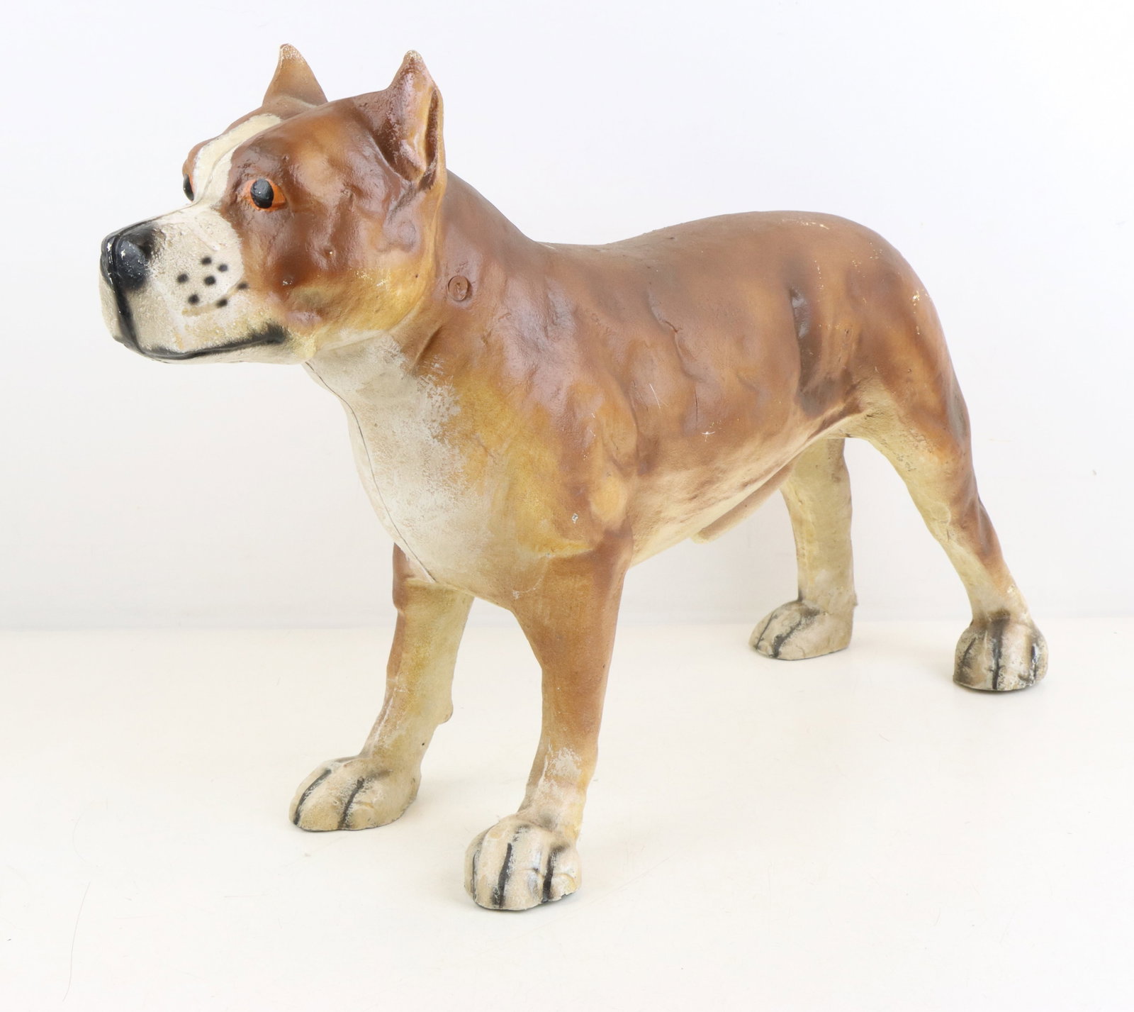 Pit Bull Terrier Cast Iron Figure: Pit Bull Terrier cast iron figure, repainted facial features, 14”h x 20”w x 6.75”d, slight wear from age and display.