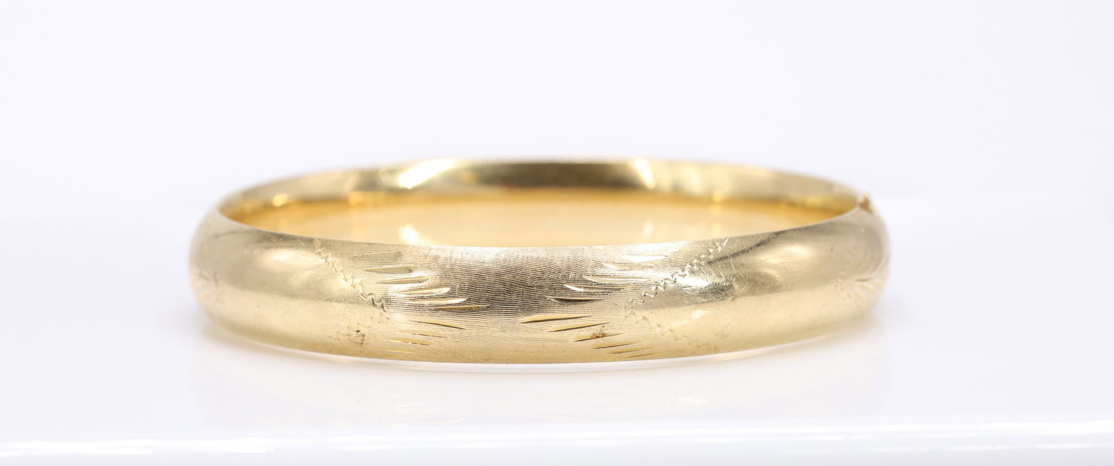14k YG Bracelet: 14k yellow gold engraved bangle bracelet with textured and etched decoration. 7" and 9.3dwt.