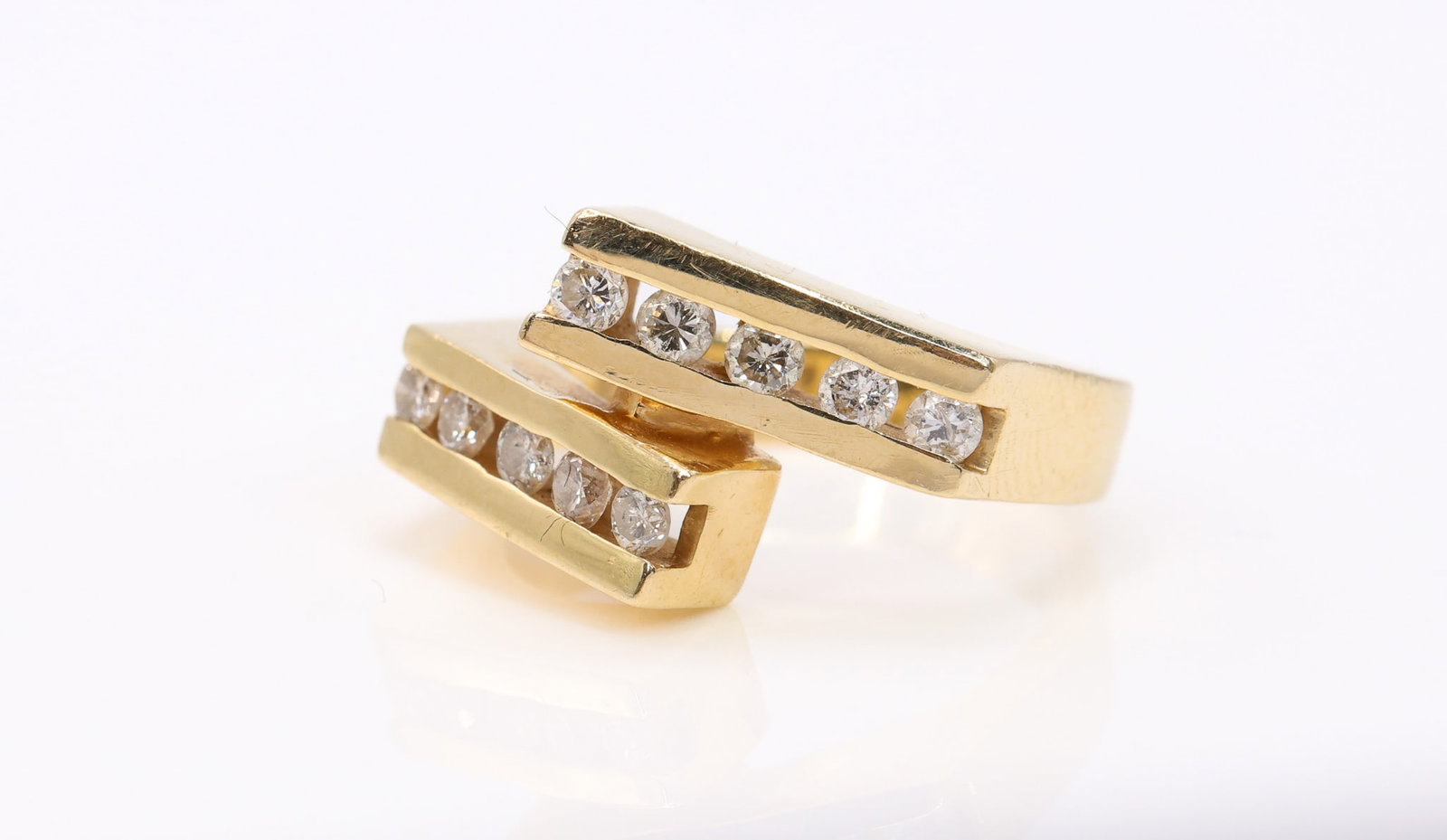 14k YG Diamond Ring: 14k yellow gold bypass ring set with channel set round brilliant cut diamonds totaling approximately 0.5 carats. Size 5.25 and 4.1dwt.
