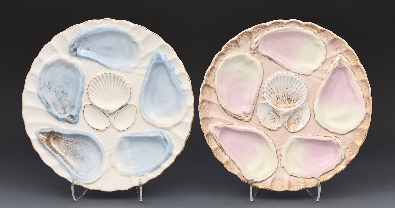 Weimar Oyster Plates: Weimar, Germany, 5-well porcelain oyster plates, complimenting designs in pastel hues, one small chip in one plate's base, hand painted with gilt decoration, late 19th/early 20th century, some wear