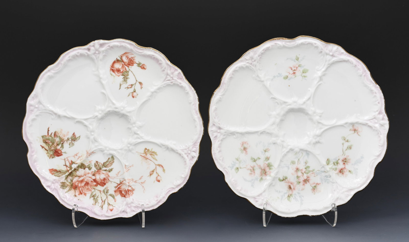 Rudolstadt Oyster Plates: Rudolstadt, Germany, 6-well complimenting porcelain oyster plates (2), hand painted floral decoration, gilt trim, wear to gilt trim from age and use. Both 8.5”w