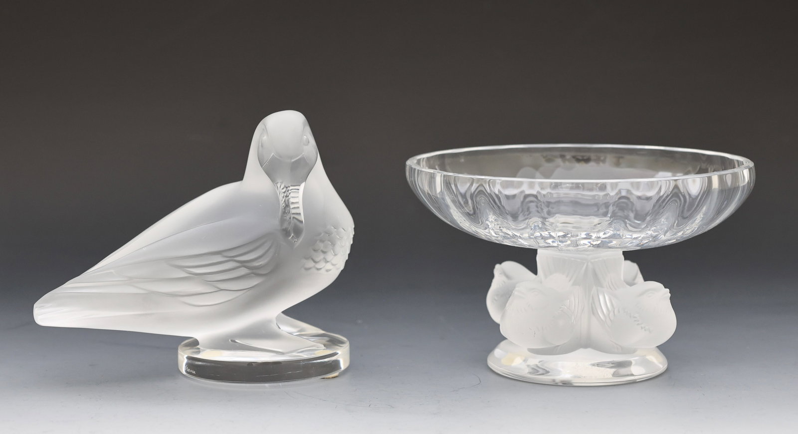 Lalique Crystal "Gaetan" Duck Figurine and "Nogents" Compote: French crystal bird decorated items, frosted and clear, including a "Gaetan" duck figurine and a "Nogents" compote. Both with engraved mark to the foot. (2) pieces. 4.25”h x 2.75”w x