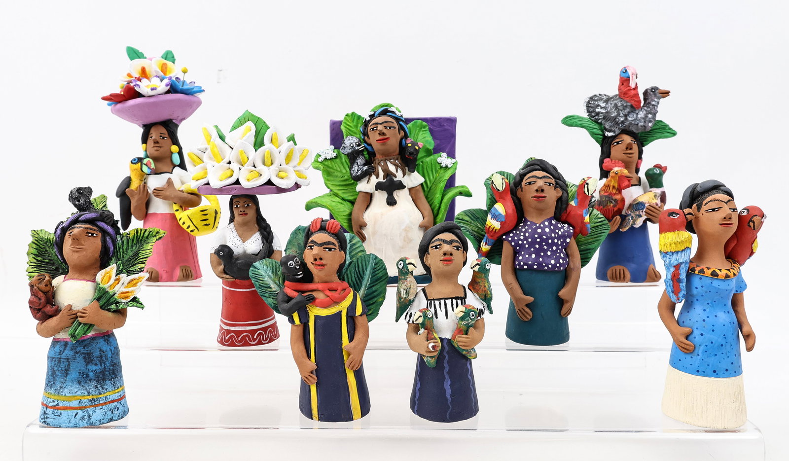 Josefina Aguilar (B. 1945): Mexican pottery figures, representing Frida Kahlo paintings. Each with an impressed signature to the interior. One figure has a repair to an arm. (9) figures. Sizes range from 4.5"h to 8"h