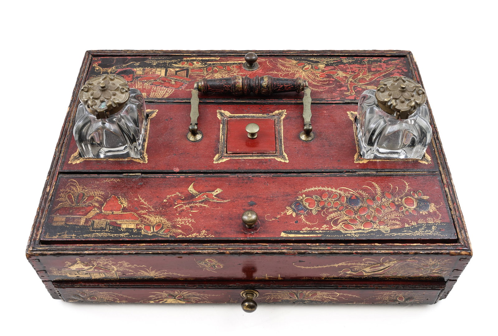 George III Japanned Ink Stand: British gilt and lacquer mixed wood ink stand with brass hardware, decorated with Japanese themes, featuring a drawer, two flip top compartments, a lift top stamp compartment under a bail handle, and