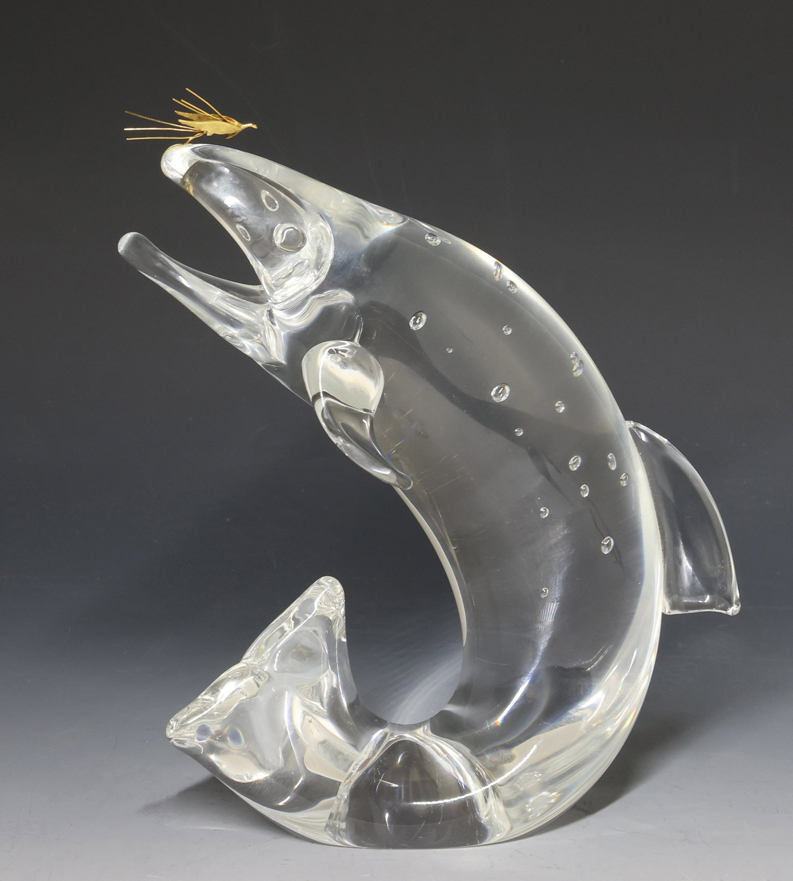 Steuben Crystal and 18k Gold "Trout and Fly": Crystal figurine of a trout leaping to catch a Royal Coachman fly made of 18k gold, designed by James Houston. Hand etched mark. 8"h x 3.25"w x 6"d