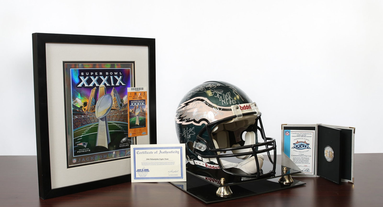 Philadelphia Eagles Super Bowl XXXIX Memorabilia: Super Bowwl XXXIX game fan package inlcudes an Eagles team signed helemet with C.O.A., game ticket stub, game program, and commemorative flip-coin with C.O.A. Helmet case, 13"h x 12"w x 15"d