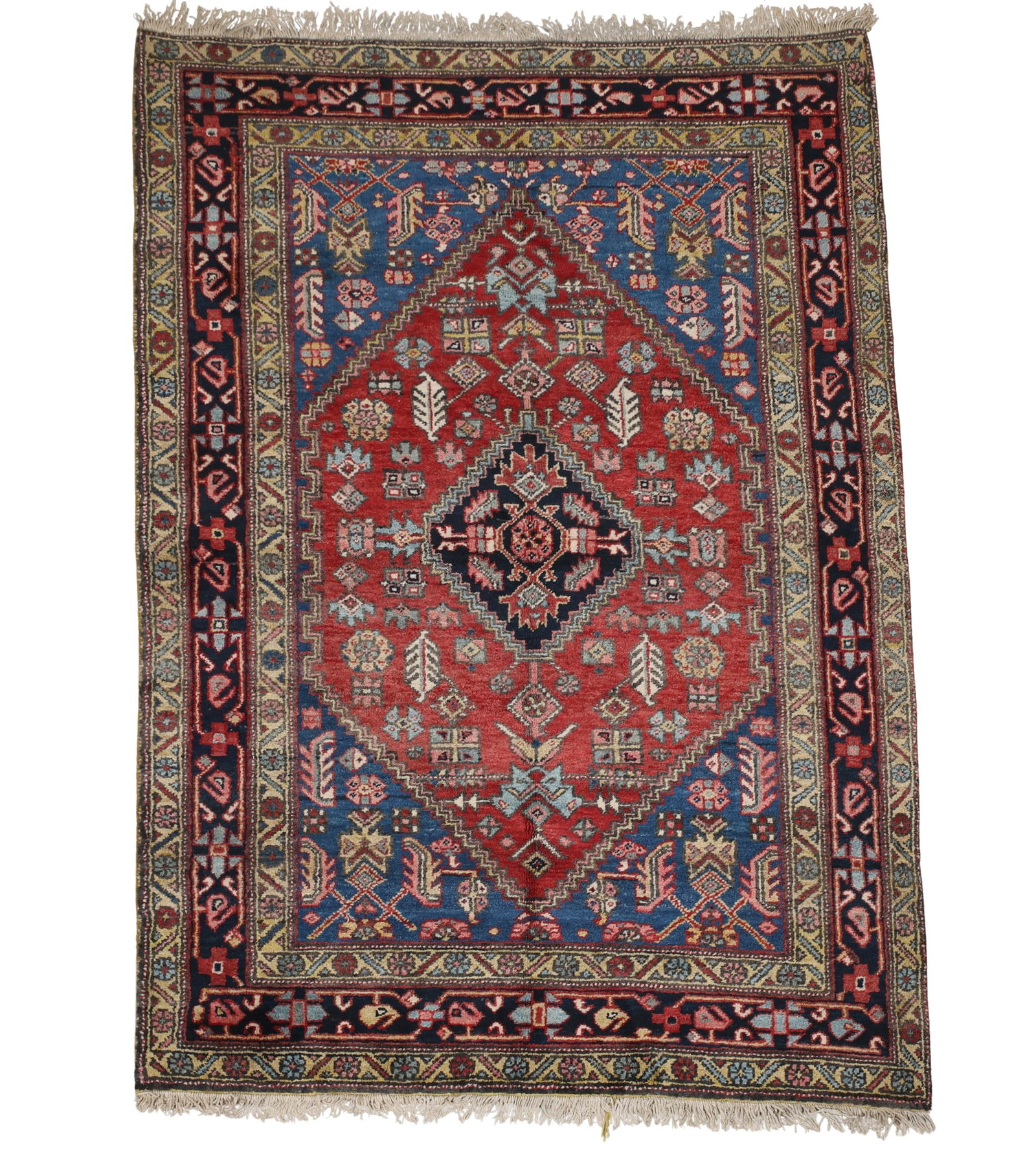 Northwest Persian Rug: Hand knotted wool pile with a jagged edge diamond central medallion and spandrels with all over arabesque motifs in the field, meandering connective boteh main border. Multi-colors of red, pink, blue,