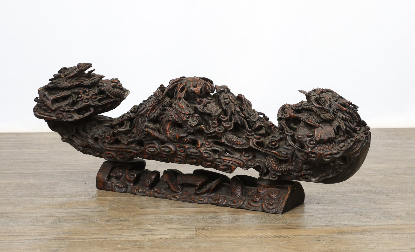 Chinese Hardwood Nine Dragon Ruyi Scepter: Qing - Republic era monumental carved harwood ruyi scepter depicting nine intertwined dragons around a central flaming pearl, the base in the form of fish in water around a scroll with inscriptions de