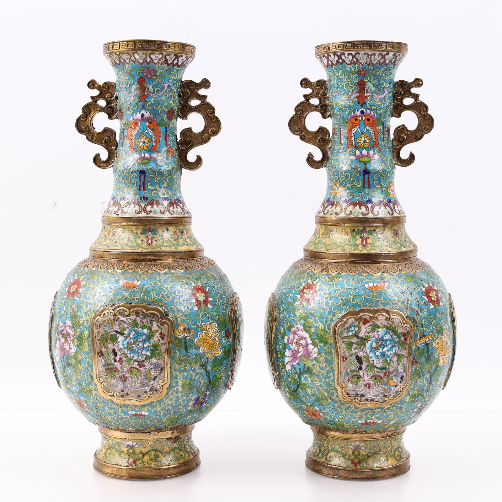 Chinese Cloisonne Vases: Republic era pair of cloisonne vases, the bodies decorated with panels depicting flowers and birds, the necks featuring lotus flowers, confronted carp, and bats on each side, all surrounded by floral,