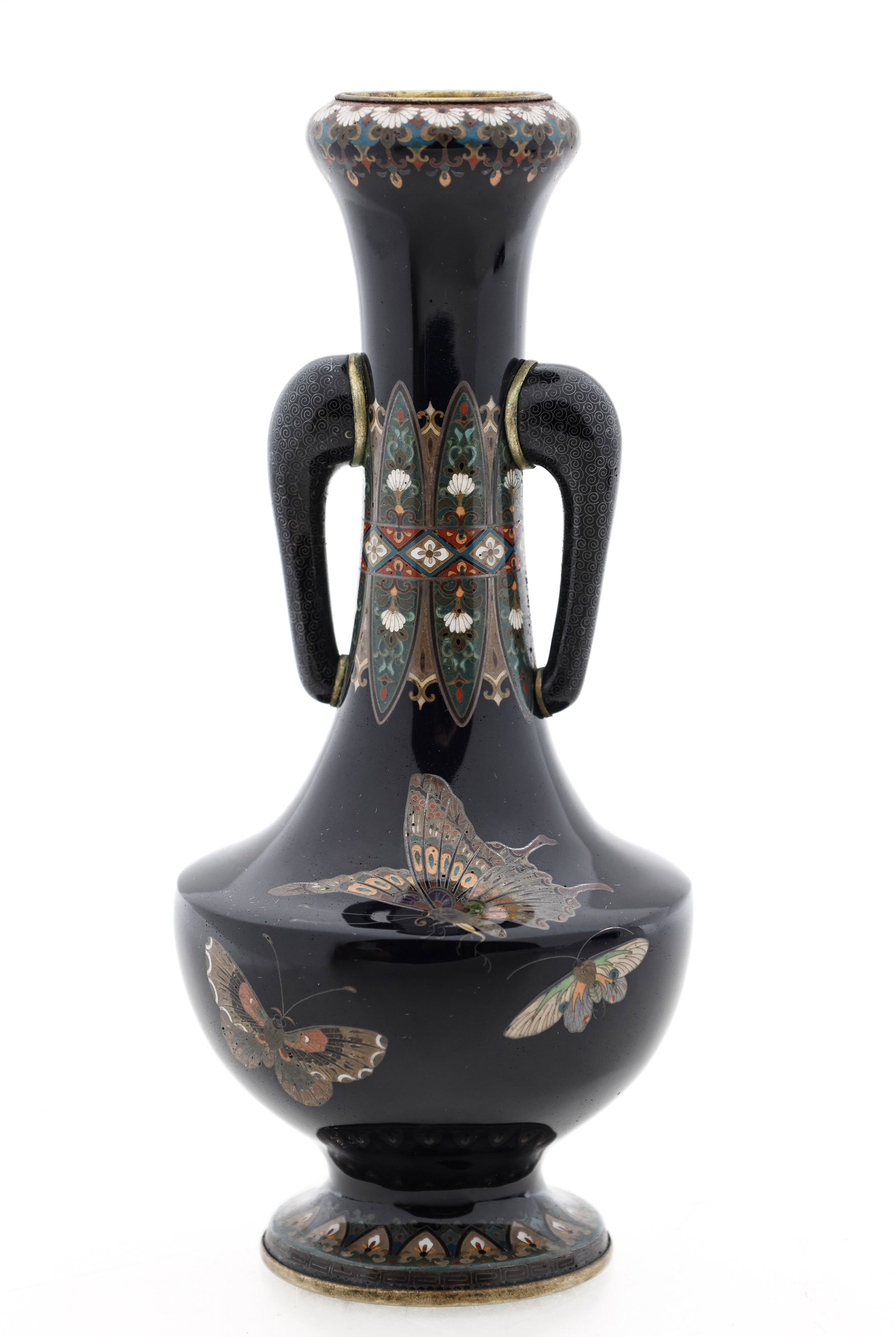 Japanese Cloisonne Vase: Meiji - Taisho silver wire cloisonne vase decorated with butterflies and lappets with floral motifs on a black ground, featuring stylized elephant head handles covered with scrolls. 6"h x 2.5"w