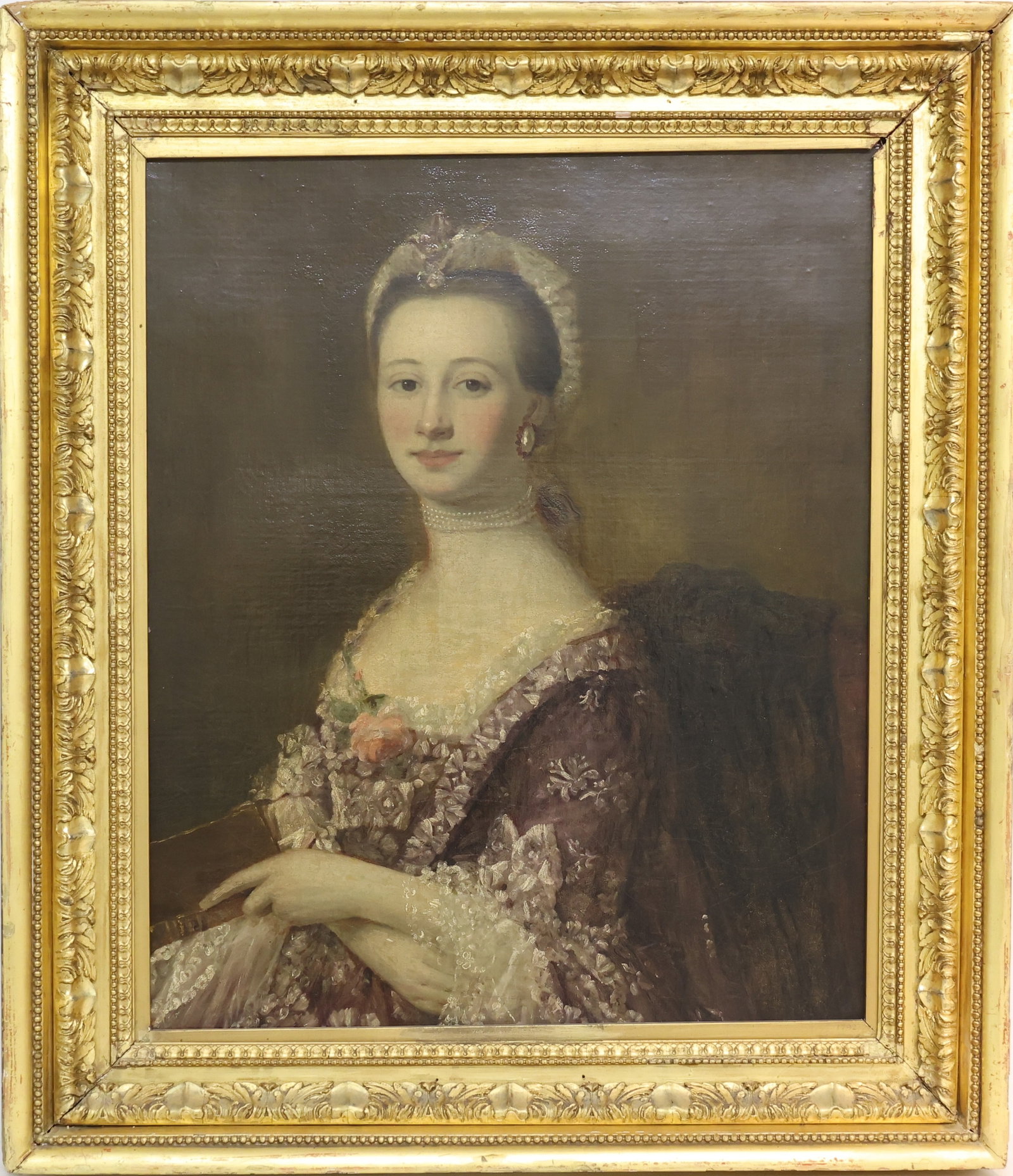 Formal Portrait: Oil on canvas, unsigned. Formal portrait of seated woman, hands folded and resting at her lap while holding a book. Condition: canvas has been relined. 29.5"h x 24.5"w and 38"h x 33"w framed