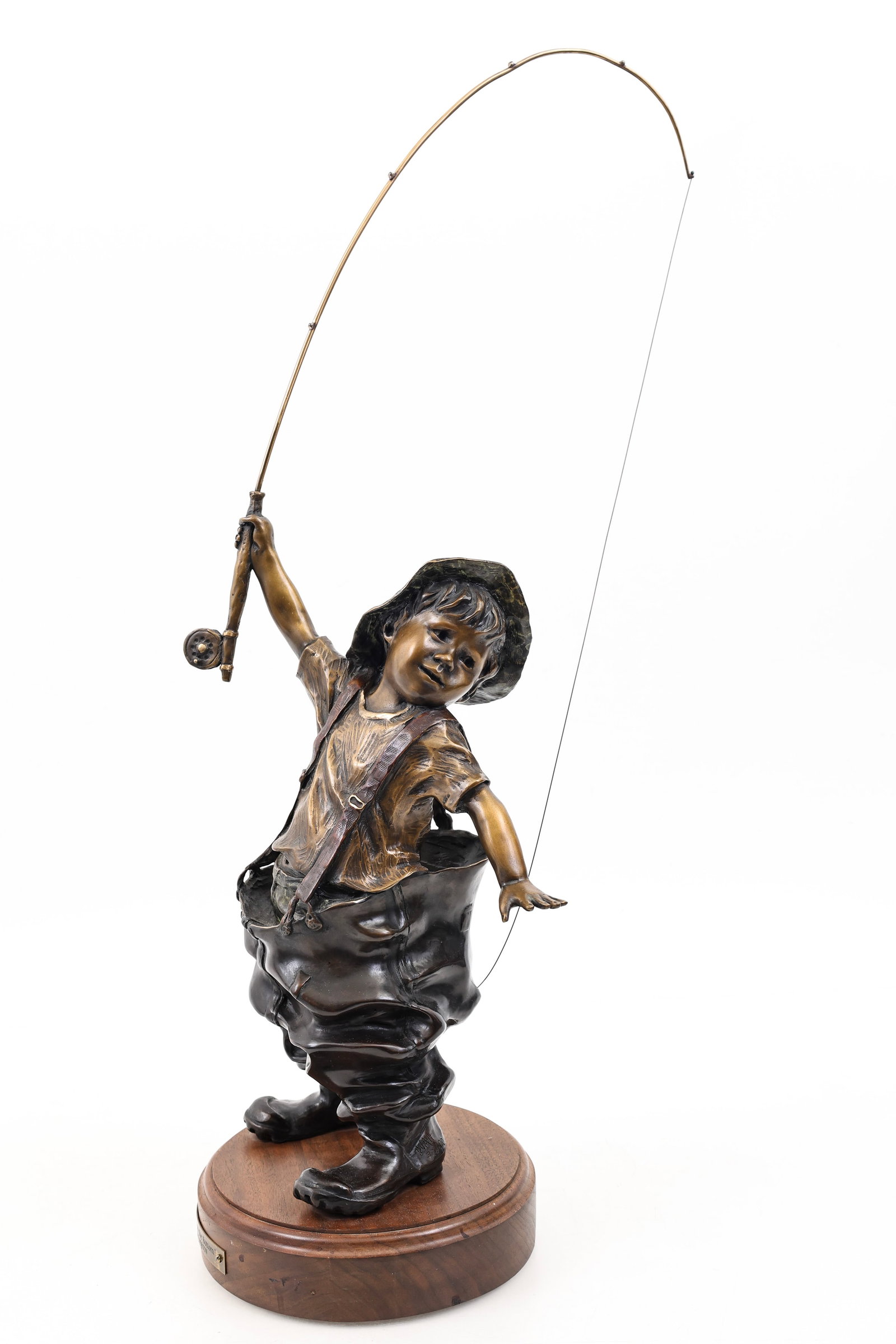 Walter Horton (1953 - 2010): Bronze sculpture, "Snagged on the Bottom", depicting a little boy fishing, mounted to a wooden stand. Impressed initials to a shoe and numbered 37/100. 25"h x 9"w x 12"d