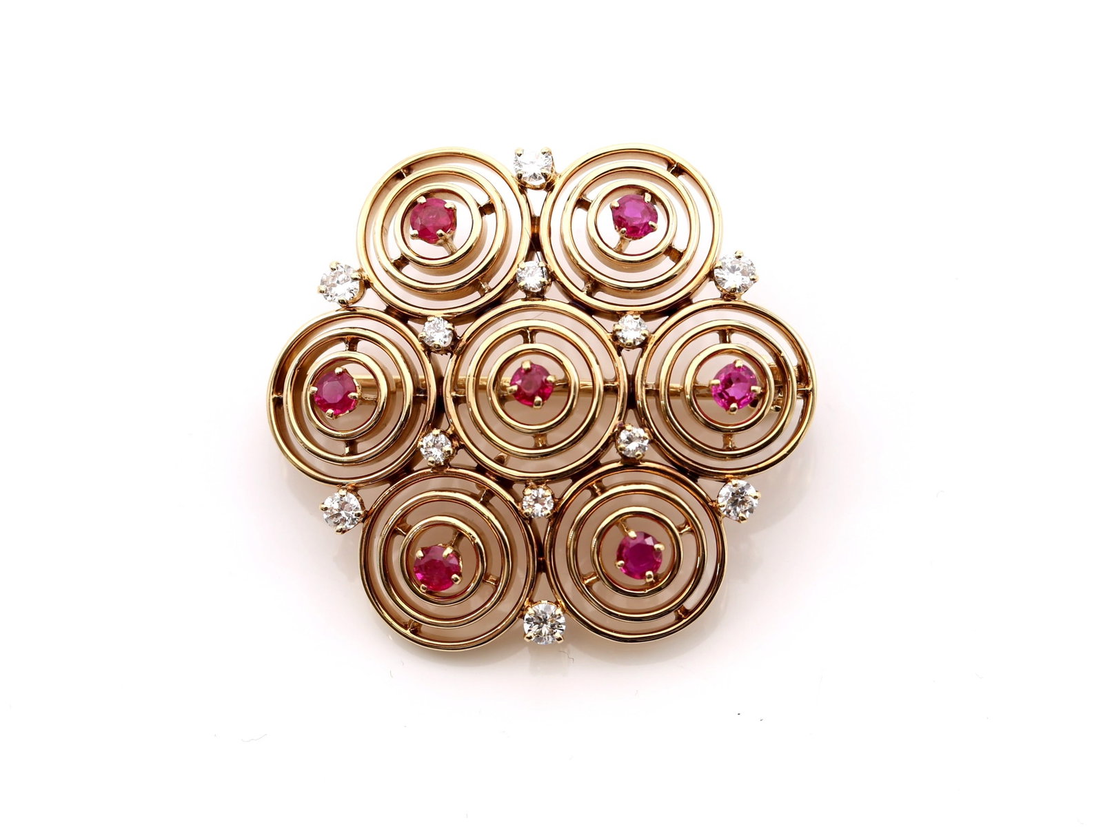 14k YG Ruby Pin: 14k yellow gold circle style pin set with twelve round diamonds totaling approximately .78 carat, G color, SI1 clarity, and seven round rubies totaling approximately .90 carat, 12.2dwt.