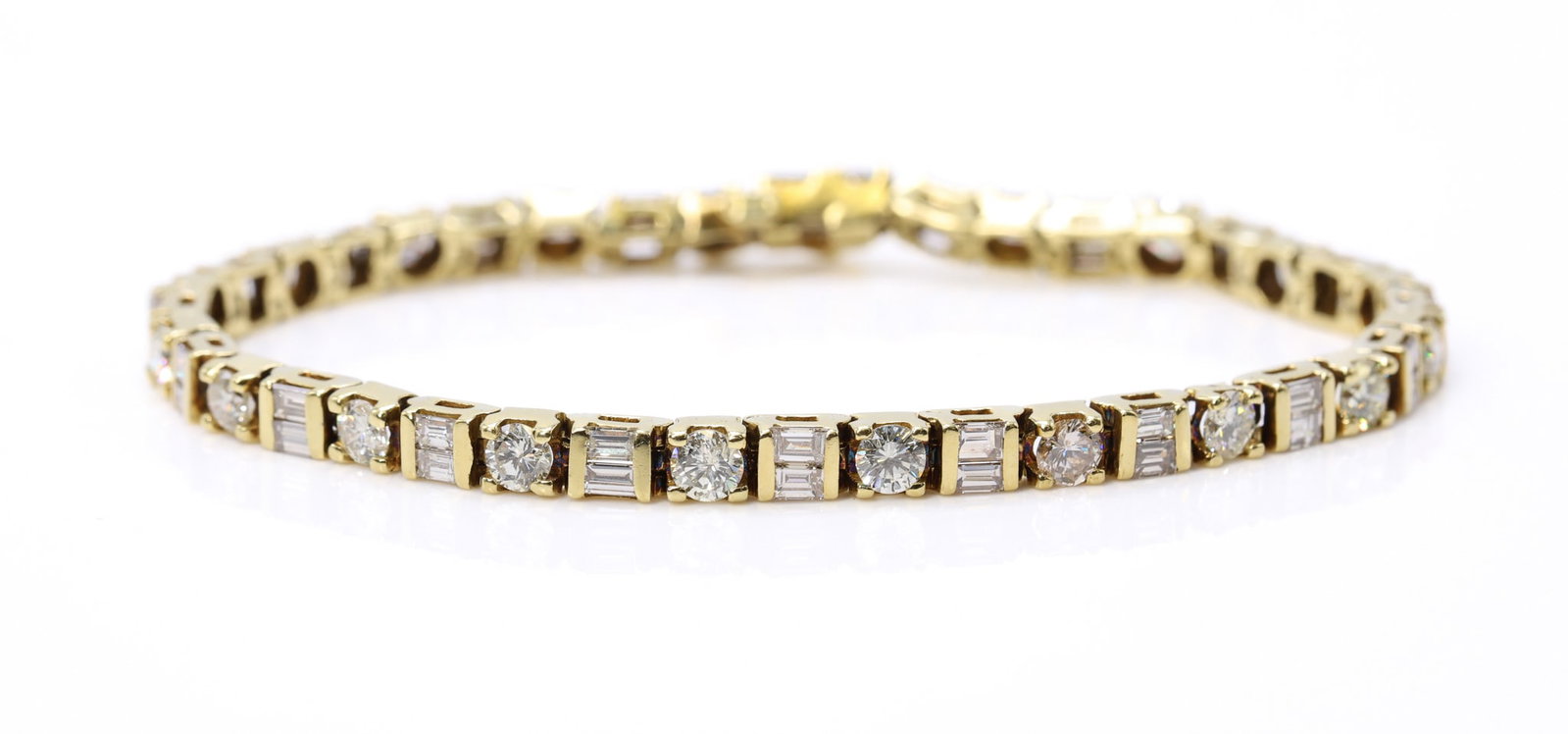 14k YG Diamond Tennis Bracelet, 6.8 CTW: 14k yellow gold diamond tennis bracelet set with 20 round brilliant cut diamonds, approximately 4.00ctw, K color, SI2 clarity, and 40 baguette cut diamonds, approximately 2.80ctw, K color, SI1 clarity