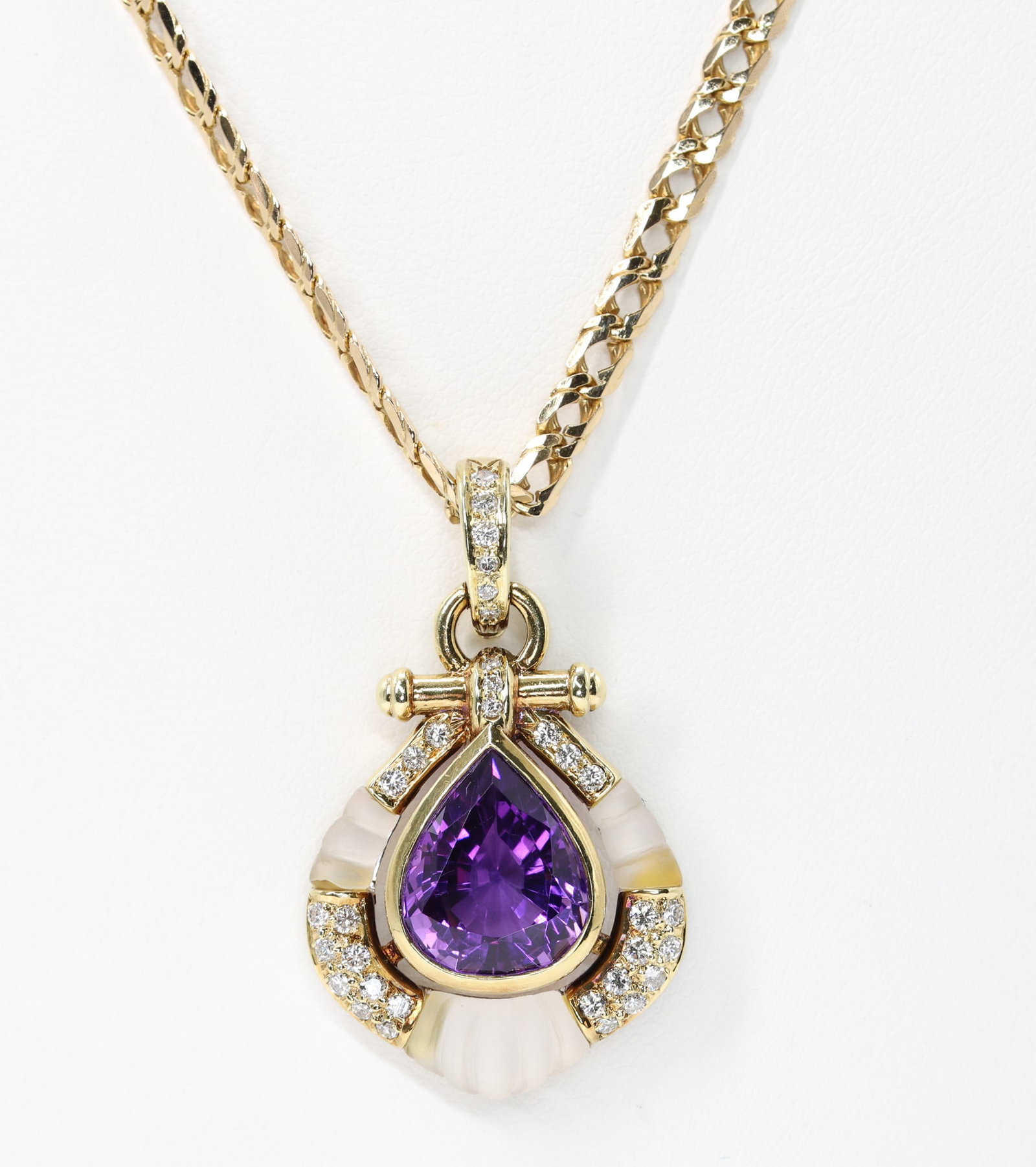 14k YG Amethyst Necklace: 14k yellow gold curb link necklace set with one pear shape amethyst, approximately 10.00 carats, (33) round brilliant diamonds totaling approximately .50 carat, I color, SI2 clarity, and white