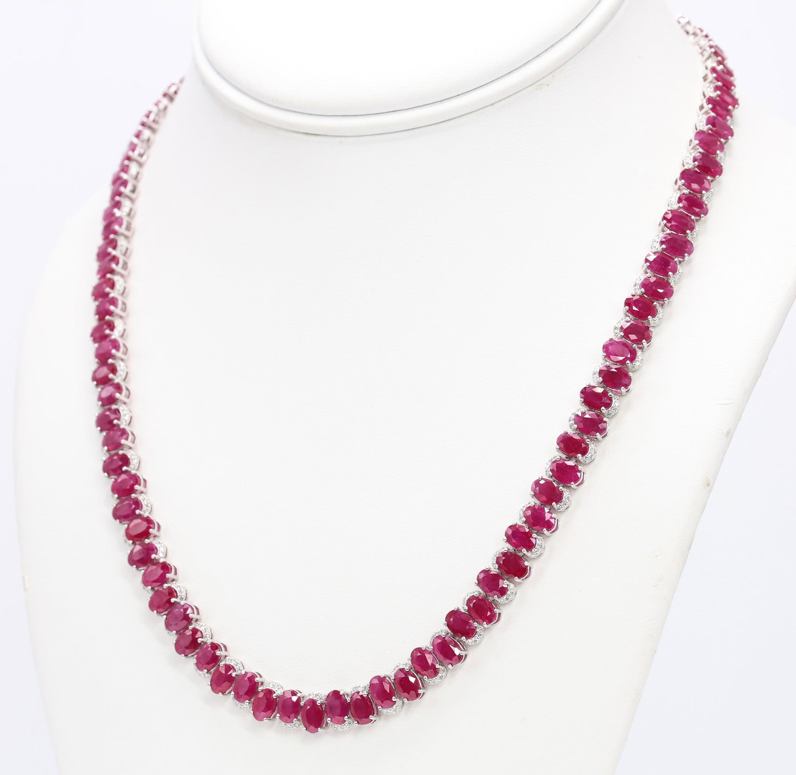 Oscar Friedman Platinum Ruby Diamond Necklace: Platinum necklace marked Oscar Friedman set with (98) oval cut Burmese rubies totaling 54.74 carats, red in color and transparent to semi-transparent, accented by (392) round brilliant cut diamonds