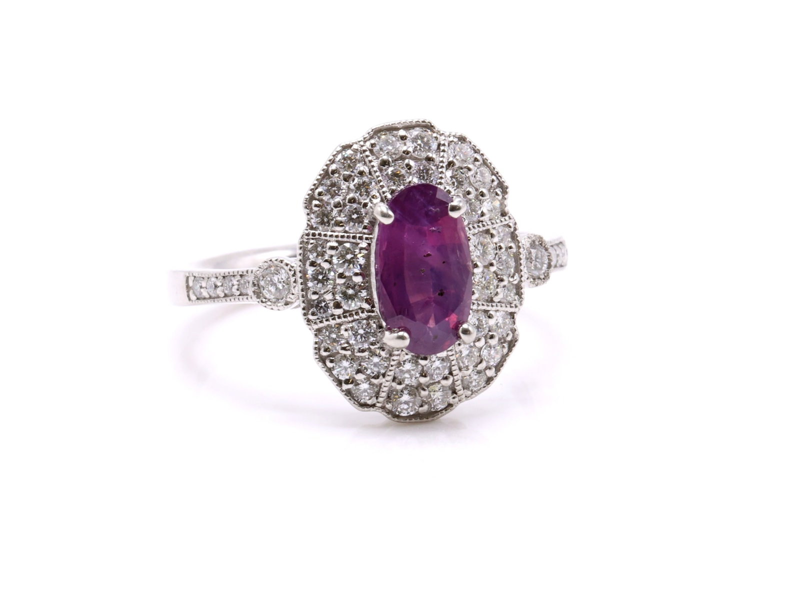 Platinum Sapphire Diamond Ring: Platinum ring set with a natural Kashmir sapphire corundum weighing 1.15 carats, oval brilliant faceted cut, pink-purple in color with intense saturation and transparent clarity, accented by round