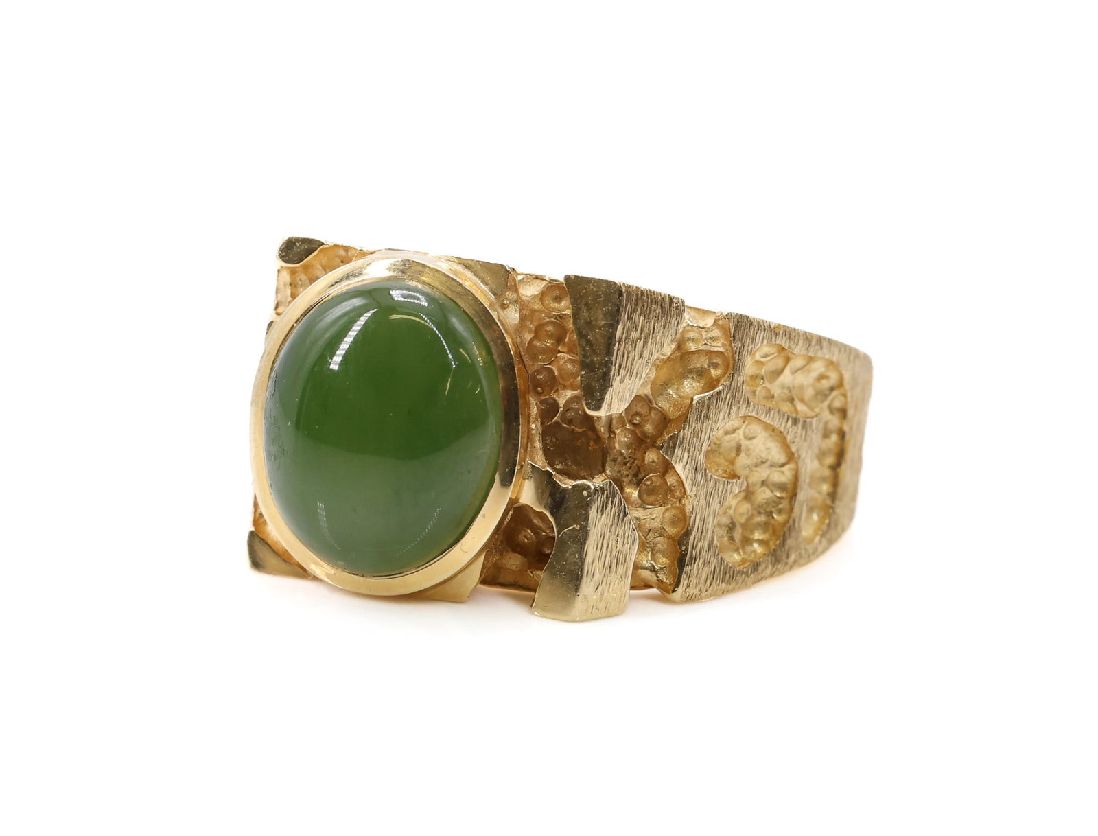 14k YG Jade Ring: 14k yellow gold ring set with 12mm jade cabochon, wide band with abstract relief decoration, size 9.25, 8.1dwt.