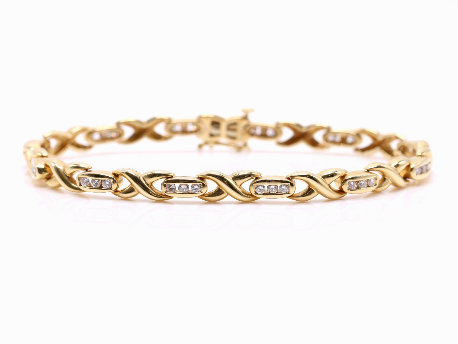 14k YG Diamond Bracelet: 14k yellow gold X-link bracelet set with bezel set round brilliant diamonds. 7.5" and 10.0dwt.