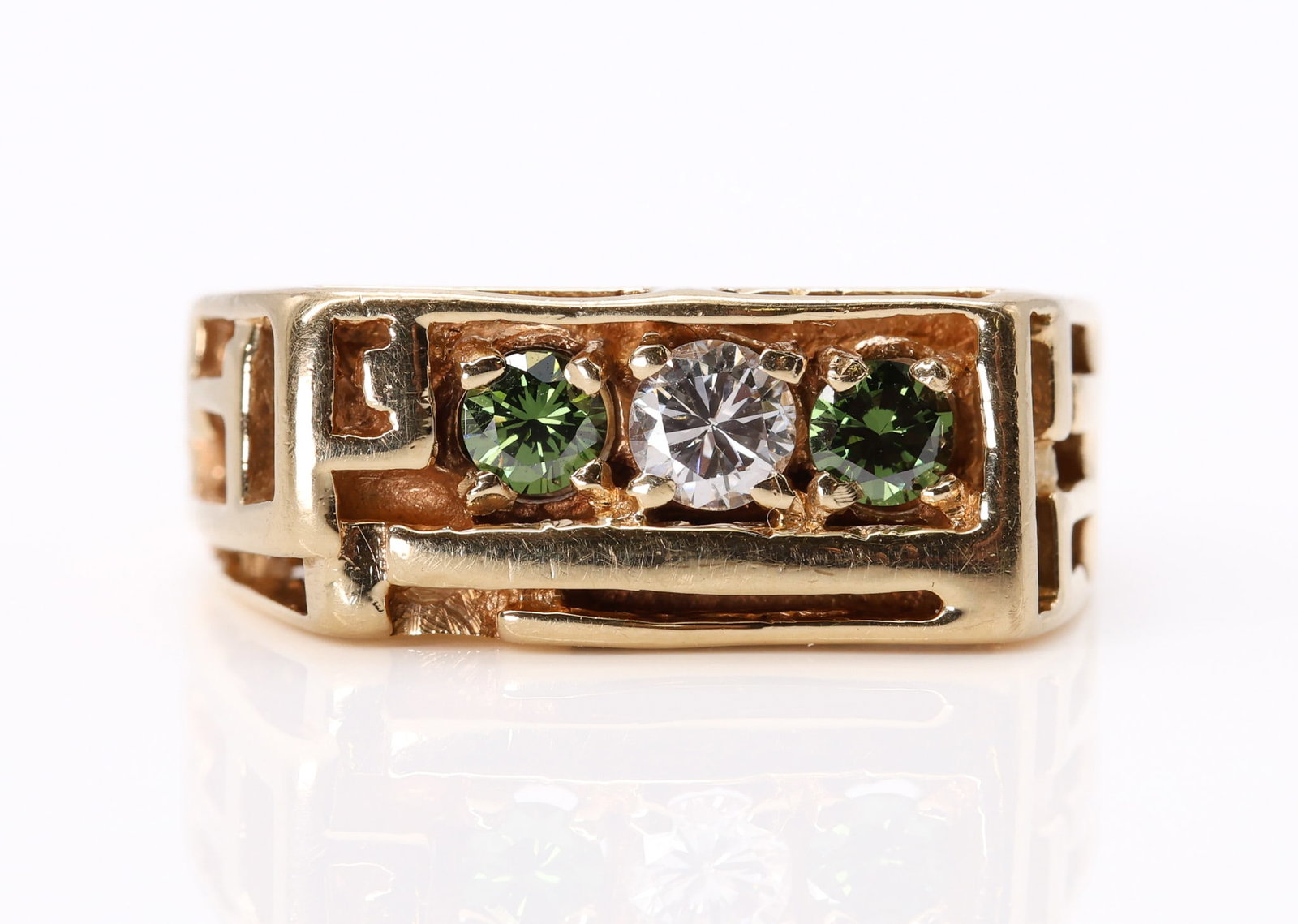 14k YG Diamond Ring: 14k yellow gold ring set with (1) white diamond and (2) green diamonds, each approximately 0.10ct, size 5.5 and 4.1dwt.