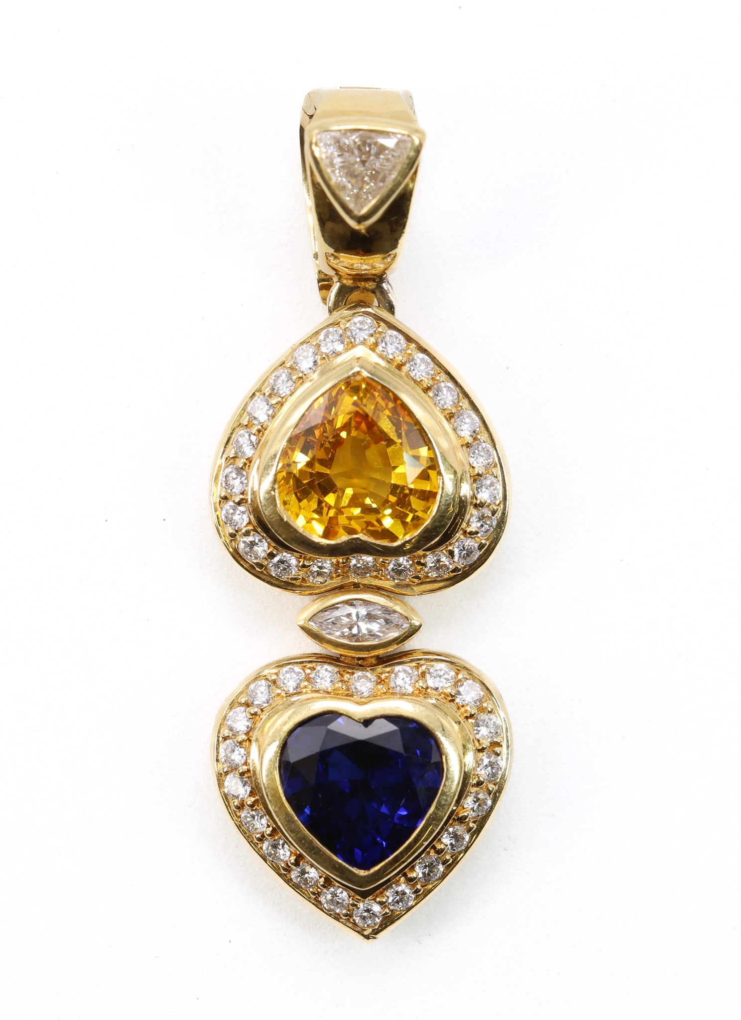 18k YG Sapphire Diamond Pendant: 18k yellow gold pendant set with heart shape yellow and blue sapphires weighing approximately 1.00ct each and diamond accents totaling approximately 0.75ctw, 1.5" and 5.4dwt.