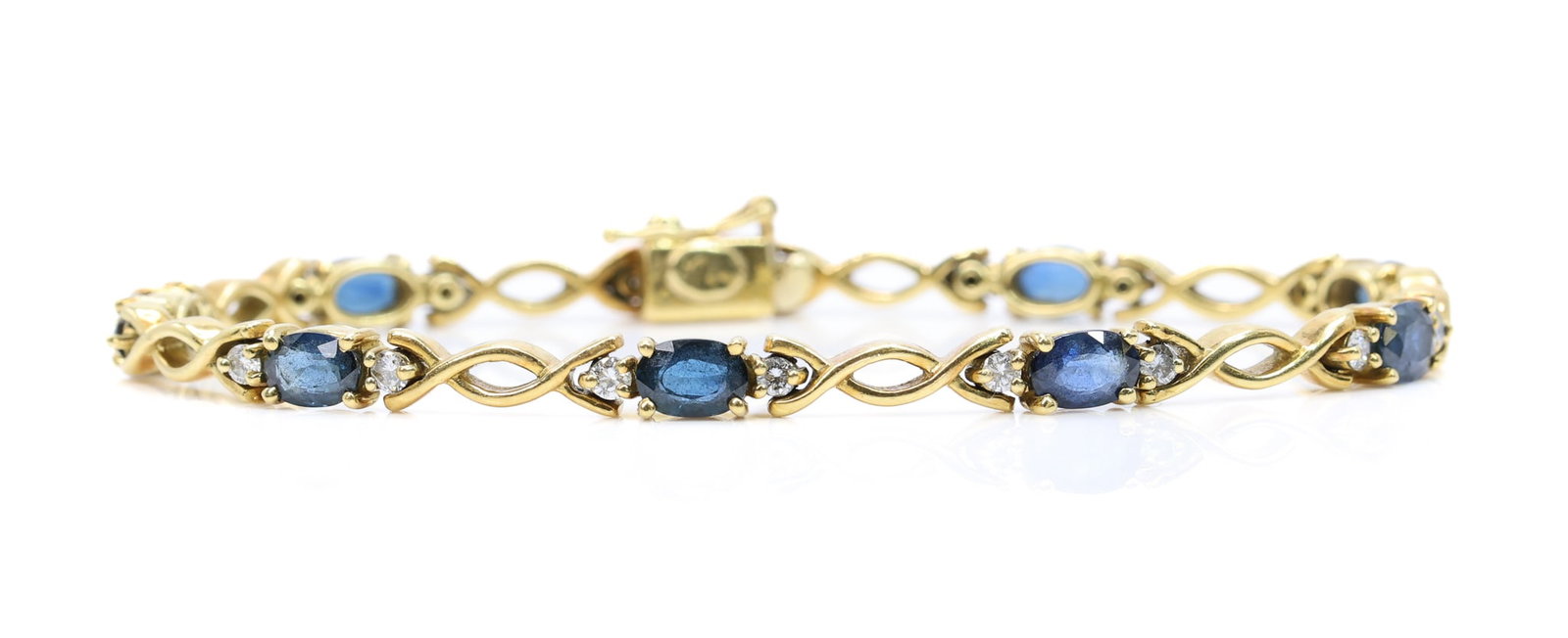 18k YG Sapphire Diamond Bracelet: 18k yellow gold bracelet set with oval cut sapphires totaling approximately 6.00ctw and round brilliant cut diamond accents totaling approximately 0.33ctw, 7.25" length and 12.1dwt.