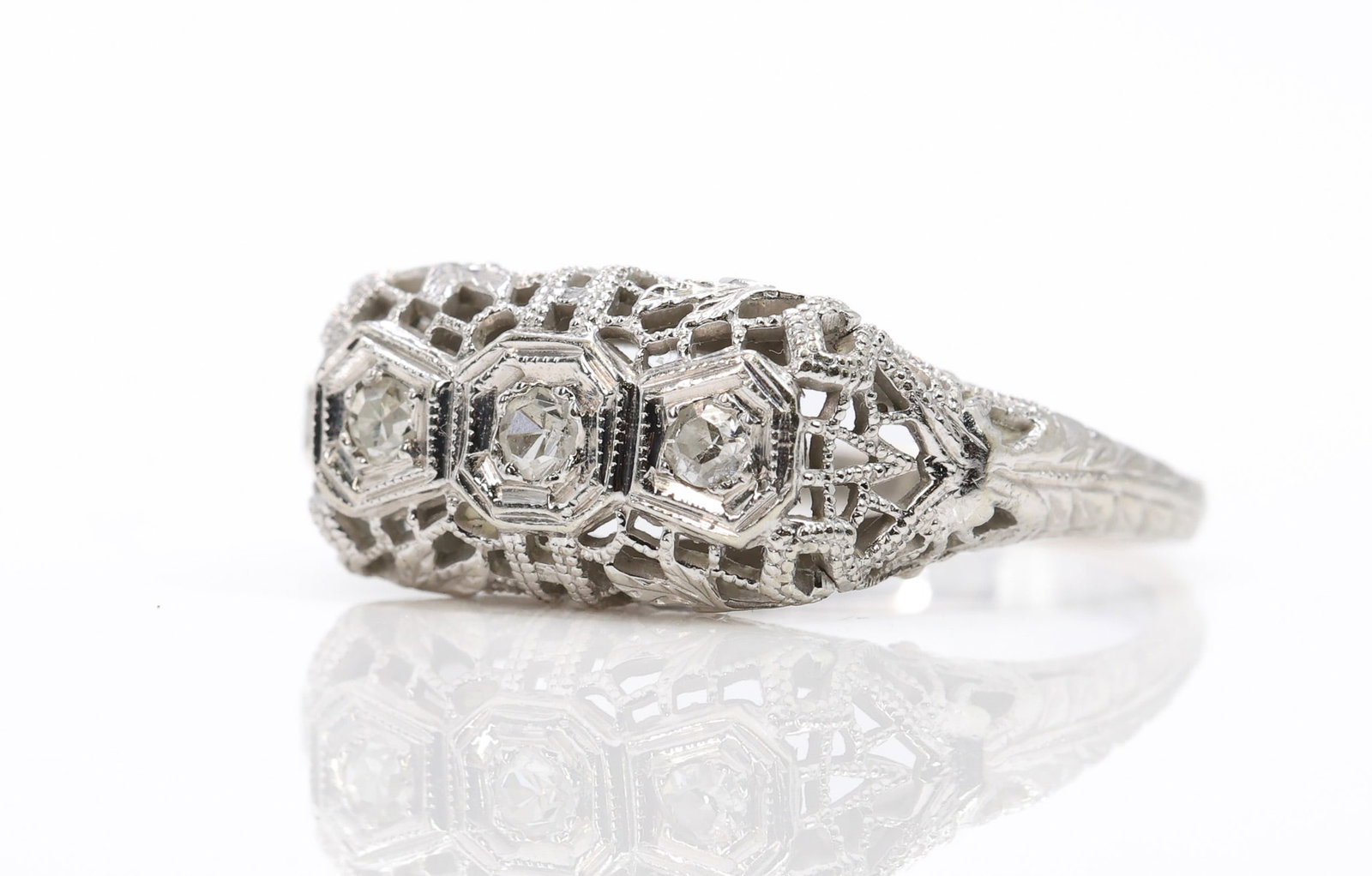14k YG Diamond Ring: 14k white gold openwork filigree ring set with round cut diamonds totaling approximately 0.10ctw, size 6.5 and 1.9dwt.