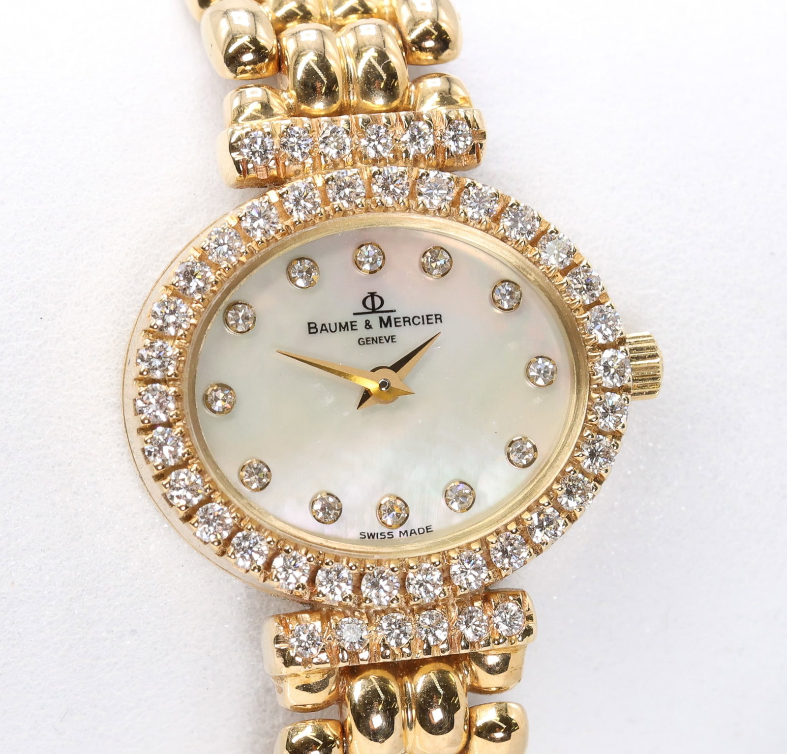 Baume & Mercier 14K YG Diamond Wristwatch: Baume & Mercier 14k yellow gold ladies wristwatch with mother of pearl dial, diamond bezel and diamond accents, 6.25"-6.5", 22.9dwt.