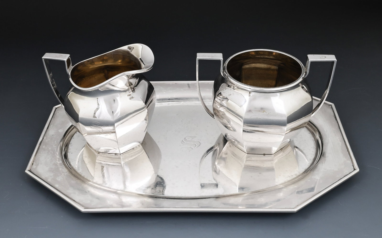 Sterling Silver Teawares: American sterling silver creamer, open sugar bowl, and tray, all of octagonal form. All marked sterling silver. Monogrammed. The tray shows significant surface wear, which be a result of lacquering;