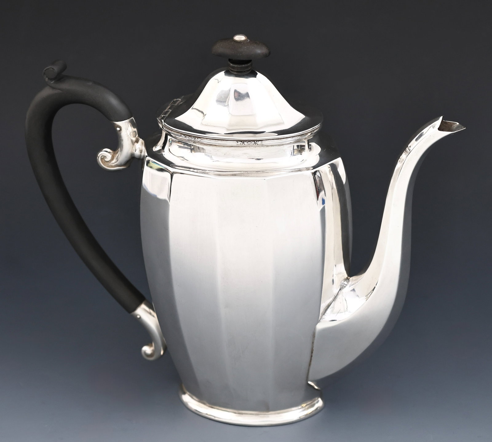 Charles S. Green British Sterling Silver Coffee Pot: Interwar sterling silver teapot with ribbed sides, ebonized handle and finial, and foliate accents to the rim. Birmingham, 1928, by Charles S Green & Co. Ltd. 8.5"h x 9.5"w. 18.65 ozt