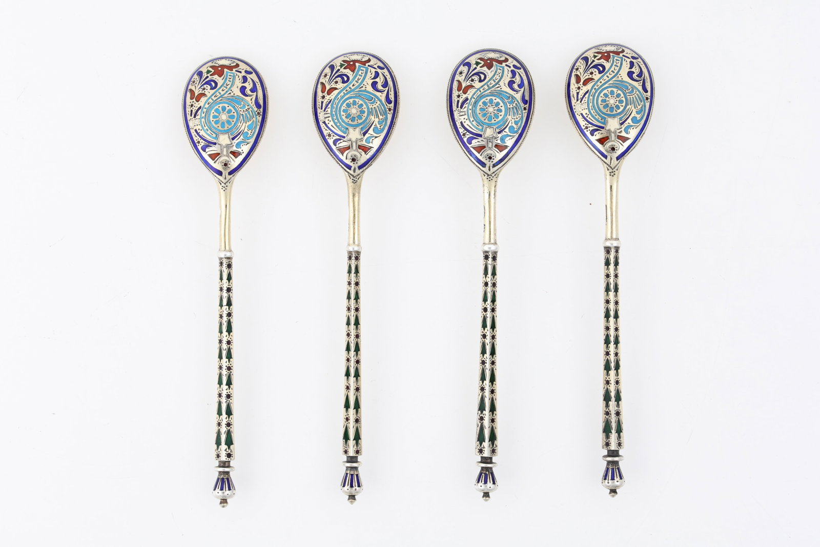 Antip Kuzmichev Imperial Russian Enameled Silver Spoons: Imperial Russian 88 zolotnik (916 silver) set of champleve demitasse spoons with polychrome foliate and geometric motifs and gold wash. 1908 - 1926 kokoshnik and maker marks for Antip Ivanovich