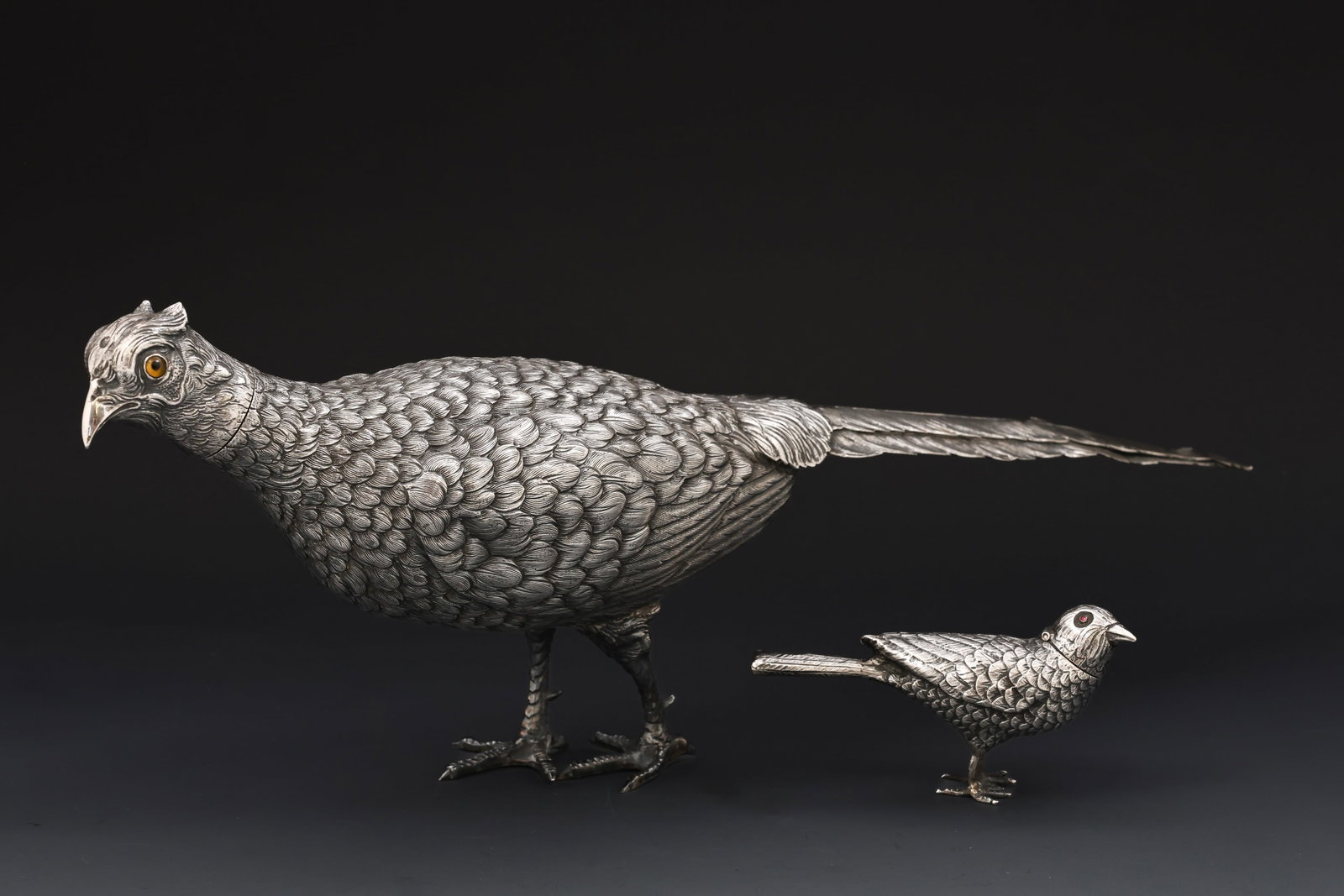 Dutch Silver Pheasant Salt and Pepper Shakers: Dutch 833 silver figural salt and pepper shakers in the form of an adult and baby pheasant, each with inset glass eyes and chased details. The head of the adult is removable and the neck of the baby