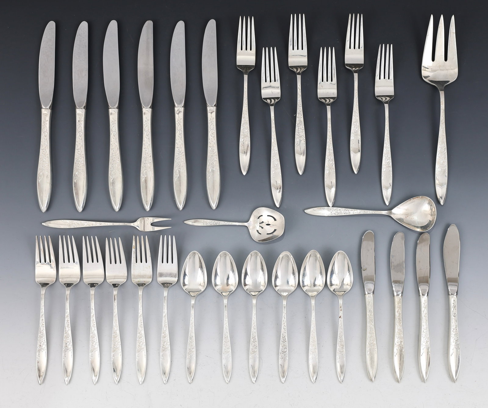Gorham "White Paisley" Sterling Silver Flatware Service for 6 With Extras: American sterling silver service, including 7.25" dinner forks, 9" hollow handle knives, salad forks, teaspoons, a hollow handle master butter, hollow handle butter spreaders, an olive fork, a cold