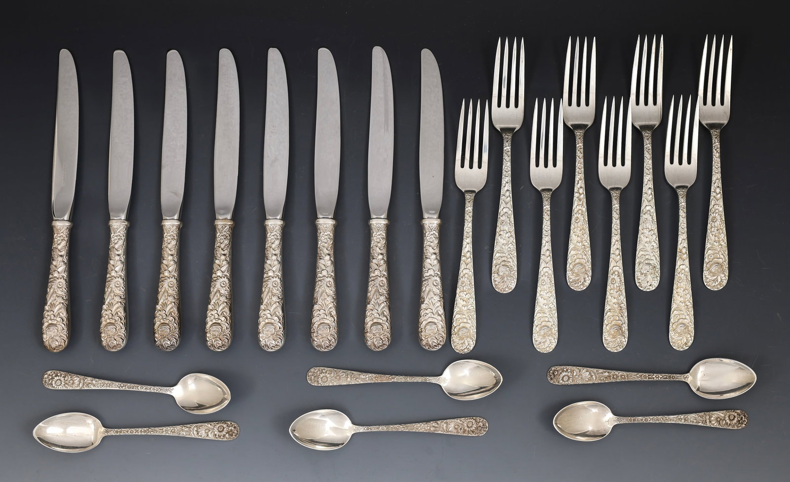 S. Kirk and Son "Repousse" Sterling Silver Flatware: American sterling silver flatware, including 7.25" dinner forks, 9" hollow handle knives, and teaspoons. Most of the forks are monogrammed. (22) pieces. 18.06 ozt excluding hollow handle pieces