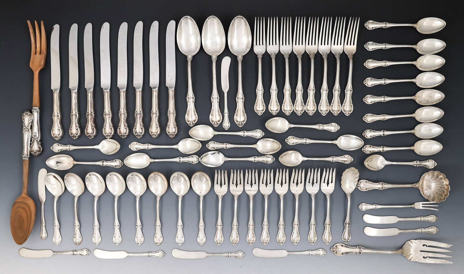 International "Joan of Arc" Sterling Silver Flatware Service for 8 With Extras: American sterling silver service, including 7.25" dinner forks, 9" hollow handle knives, salad forks, soup spoons, teaspoons, butter spreaders, an olive fork, a two-piece salad serving set (10.5"),