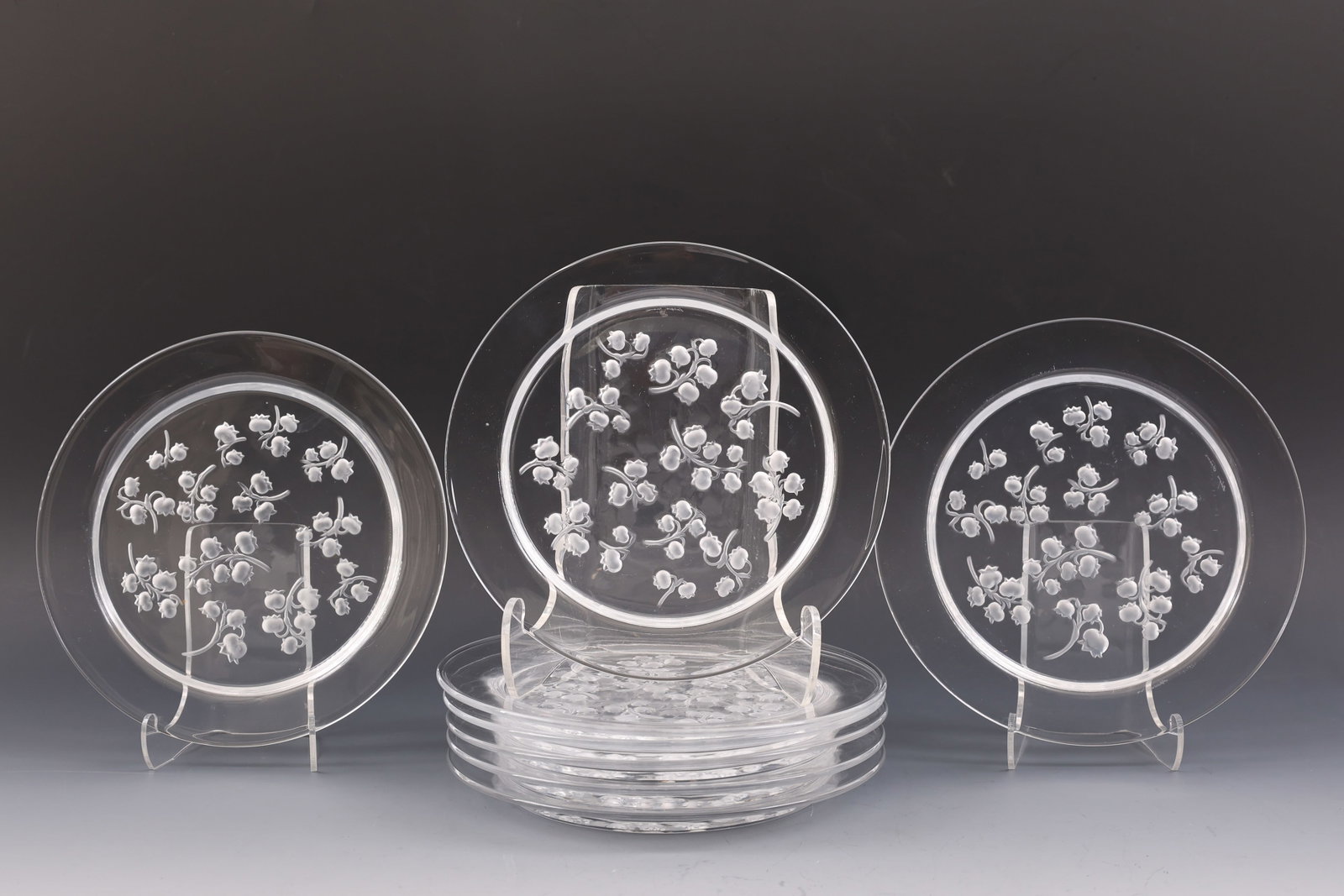 Lalique "Muguet" Salad Plates: French molded crystal salad plates, frosted lily of the valley motif on a clear background, with engraved markings. A set of (8). 8.25"w