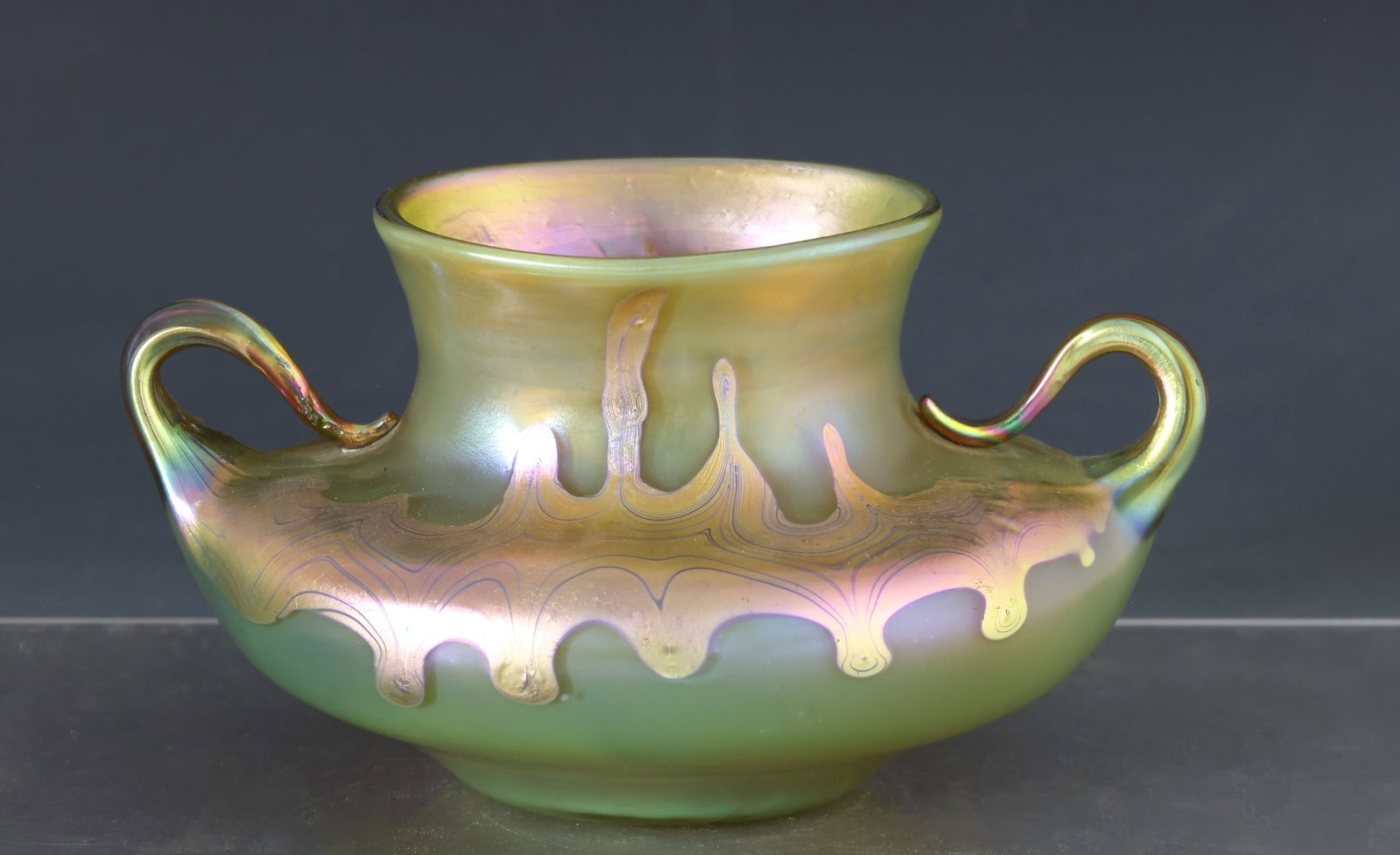 Loetz Phanomen Glass Vase: Austrian Art Nouveau glass squat vase with applied handles, Phanomen GRE-29 decor variant with silver-yellow iridescent bands on a yellow bronze ground. Etched Loetz, Austria to the pontil. 5"h x 8.5"