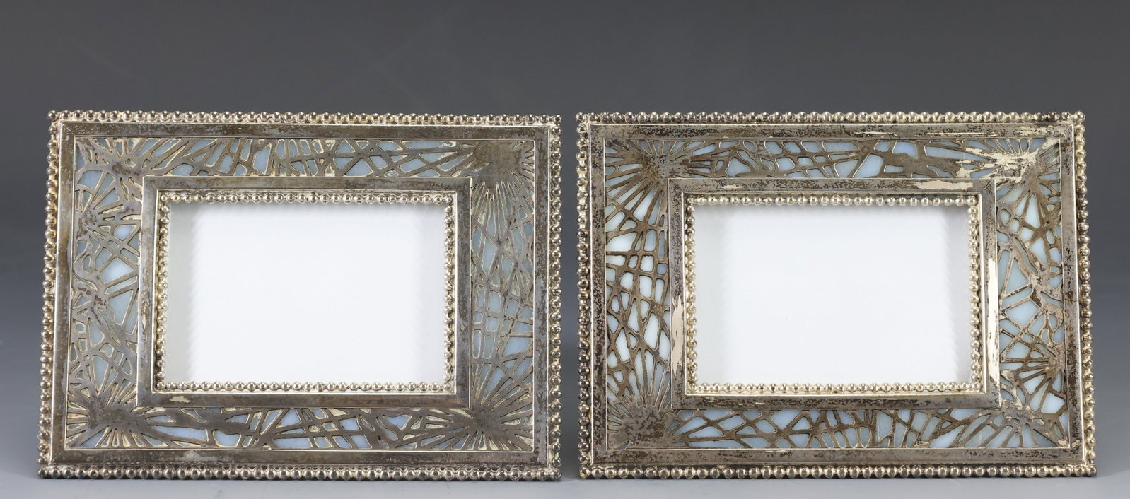 Tiffany Studios "Pine Needle" Frames: Silvered bronze pair of no. 941 frames with light blue mottled slag glass. (2) pieces. 4.25"h x 6"w, sight 2"h x 3.25"w
