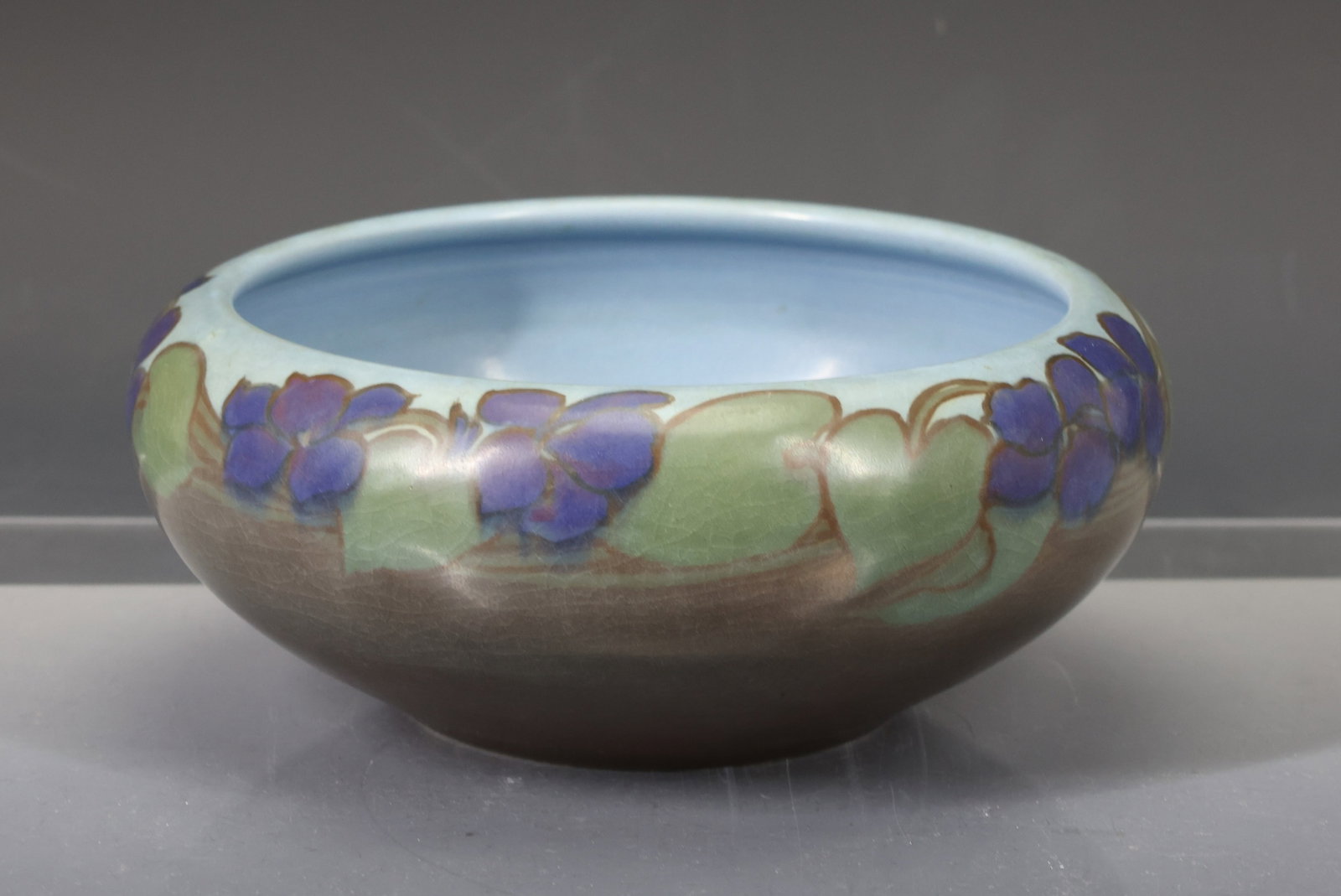 Rookwood Console Bowl: Arts and Crafts pottery console bowl decorated with violets, model no. 957C, vellum glaze. Marked for artisan Edward G. Diers, and dated 1916. 3.25"h x 7.75"w