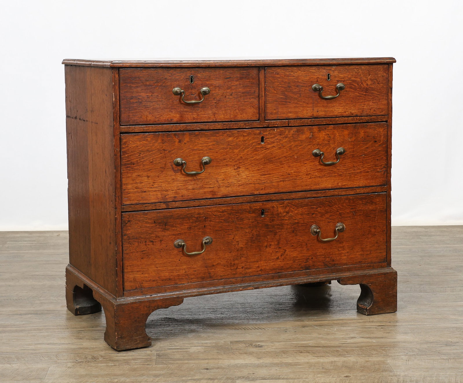 Georgian Chest of Drawers: Oak with a molded chamfered overhang edged top, two short over two graduated drawers, on shaped feet. 32"h x 37"w x 21"d