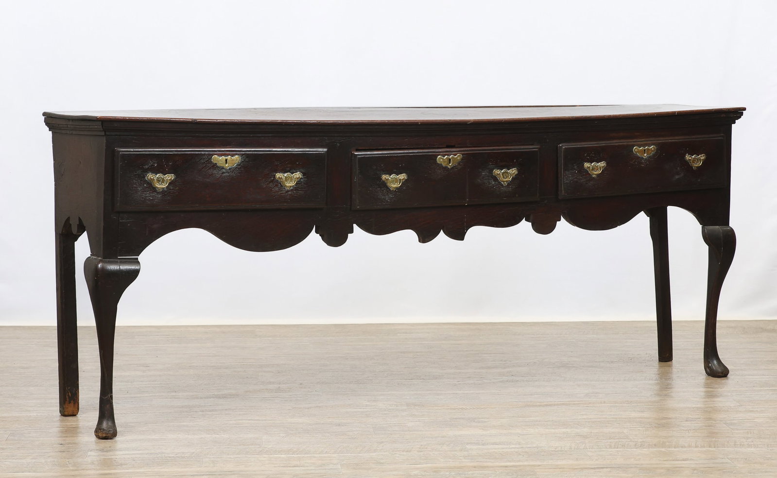 18th c. Oak Low Dresser: Oak case with pine secondary, rectangular top with molded cornice over three drawers, scrolled shaped apron on straight molded back legs with front cabriole legs and pad feet. Pulls have been