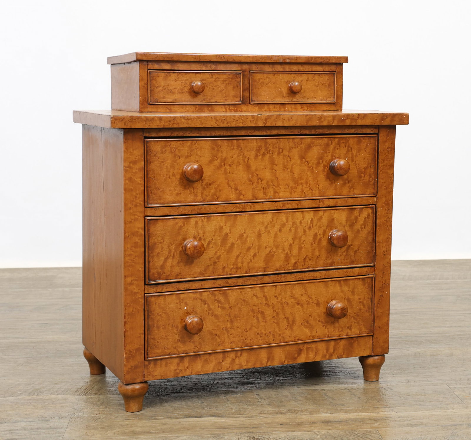 Diminutive Bird's Eye Maple Veneer Chest of Drawers: Rectangular two jewelry drawer top over three drawers on toupe feet. cracking to the veneer. 21"h x 19"w x 11"d