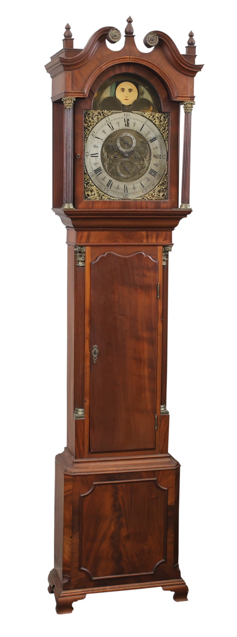 Early 19th c. British Tall Case Clock: Mahogany with a broken arch pediment, reeded hood columns, shaped waist door flanked by ormolu mounted and reeded Corinthian columns, canted plinth base, on ogee bracket feet. 8-day brass movement