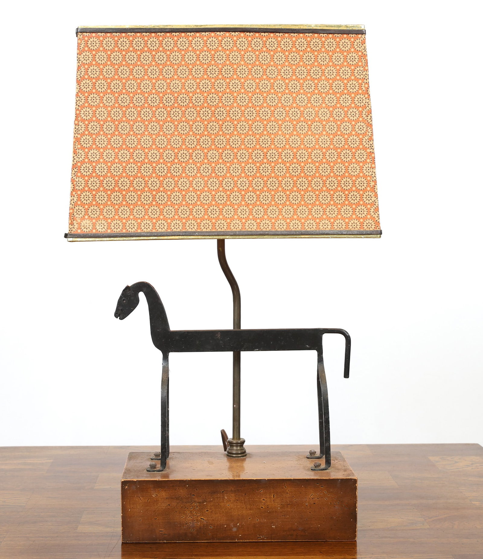 Sculptural Horse Table Lamp: Table lamp with an abstract wrought iron sculpture of a horse mounted to an oak black, featuring a rectangular shade with a stylized rosette motif. In working condition. 22"h x 13"w x 8"d