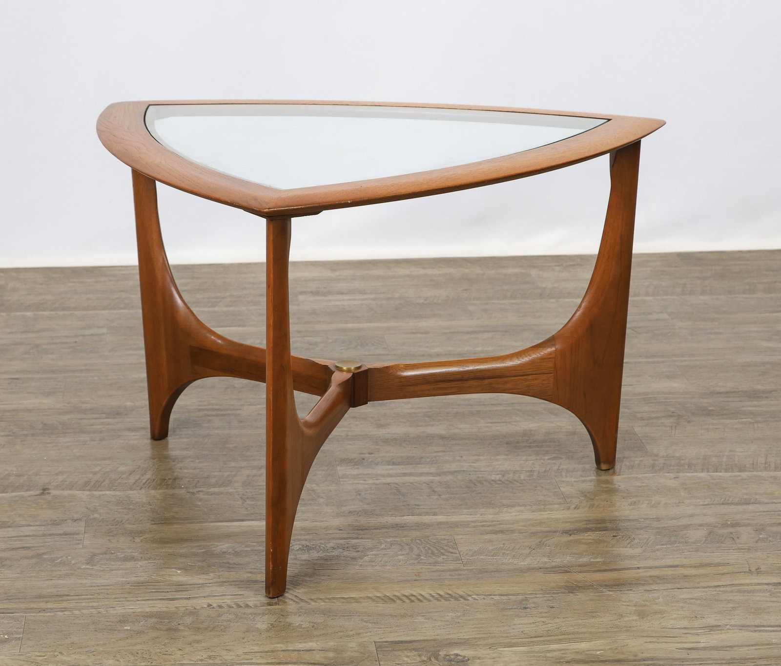 Lane "Silhouette" Side Table: No. 1044-21 walnut wedge table with a sculpted frame and inset glass top. Stamp marked and dated 1964. 18"h x 28.5"w x 28.5"d
